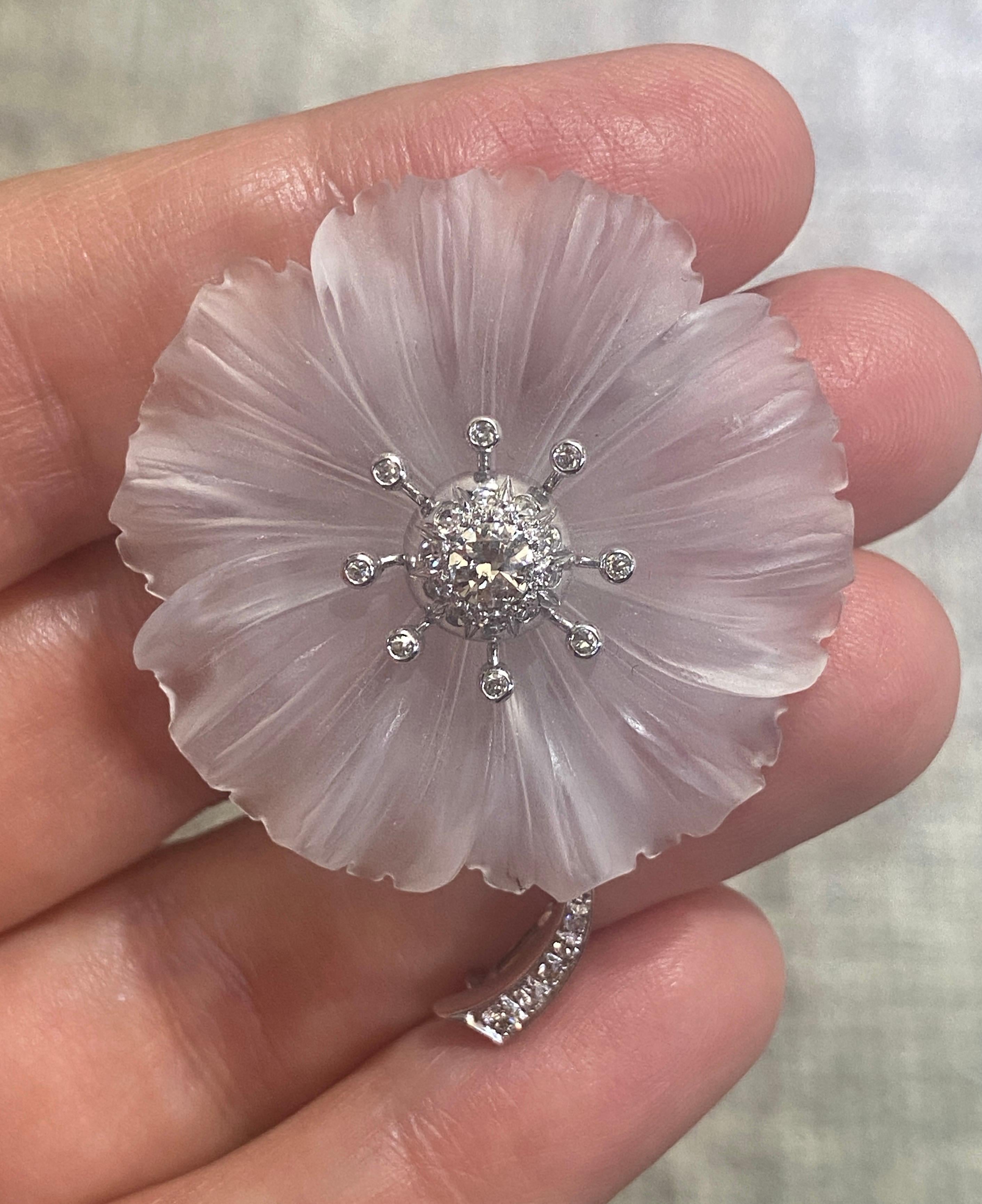 This is a stunningly elegant rock crystal and diamond brooch made in Austria in 1930s. The rock crystal is masterfully carved and gives the appearance of translucent petals on the flower. Although almost a century old, this brooch is as wearable