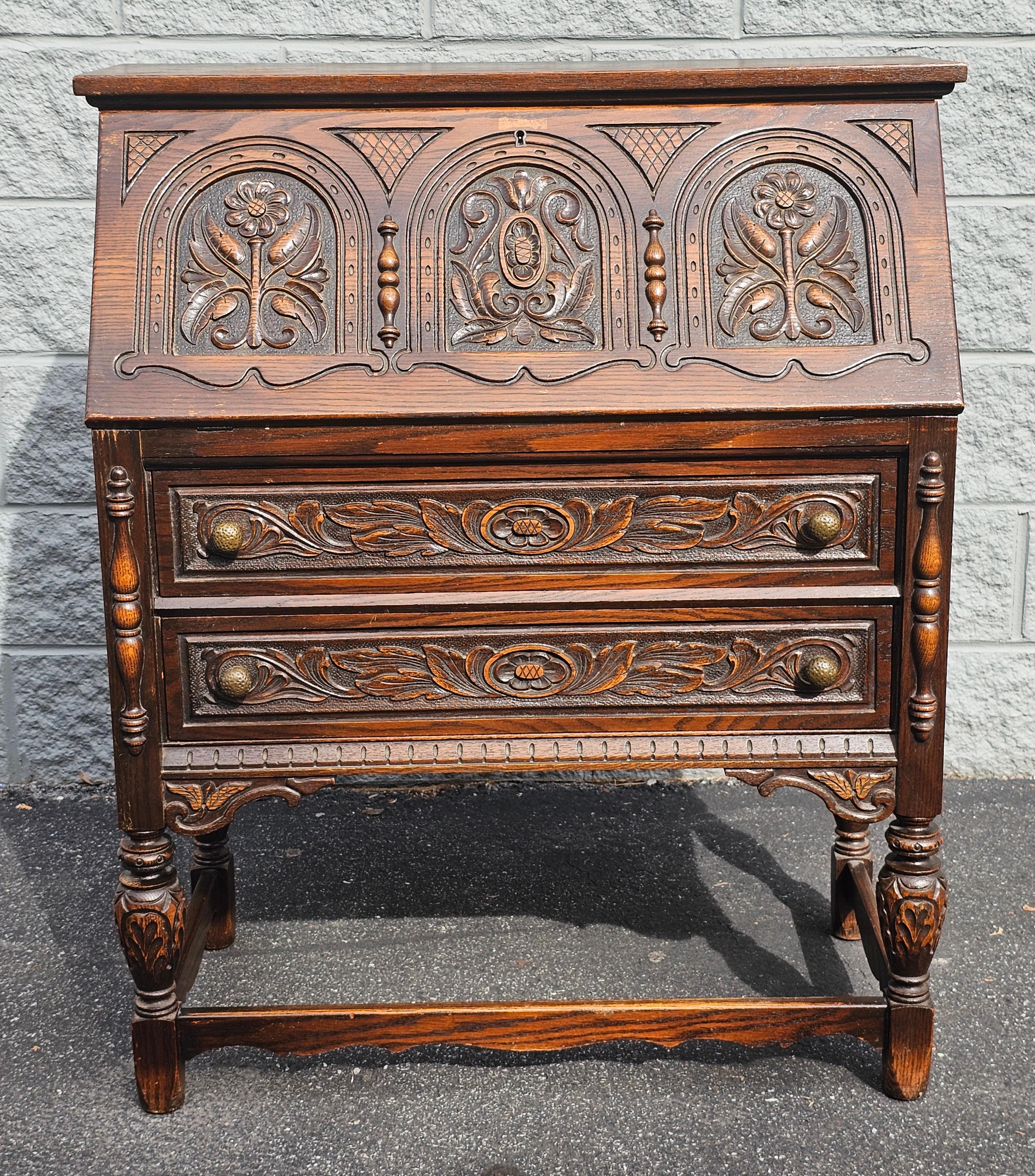 A Jacobean-style slant front Hancrafted and handcarved by the renowned Rockford Chair and Furniture Company. Founded in 1876 by Swedish settlers, the company has a rich heritage of fine craftsmanship and timeless design.

This stunning slant front