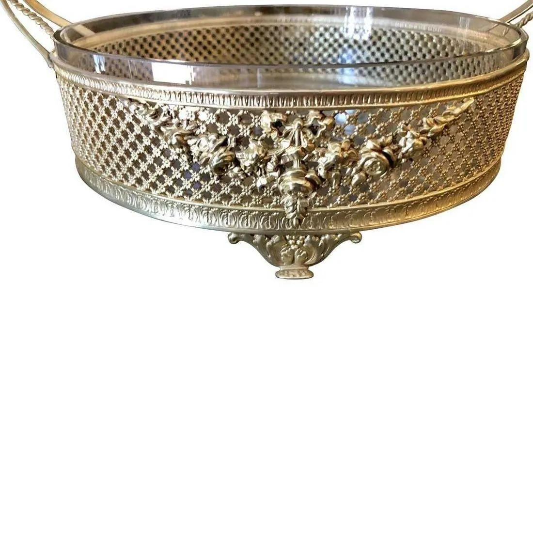 Polished brass handled basket with ivy leaf and ribbon design.
Cut-glass insert. that is removable for cleaning.
Dimensions are approximate - Width 11 Depth 8.75 Height 10.