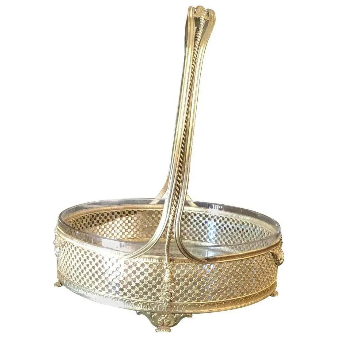 Polished brass handled basket. Cut-glass insert. Dimensions Width 11