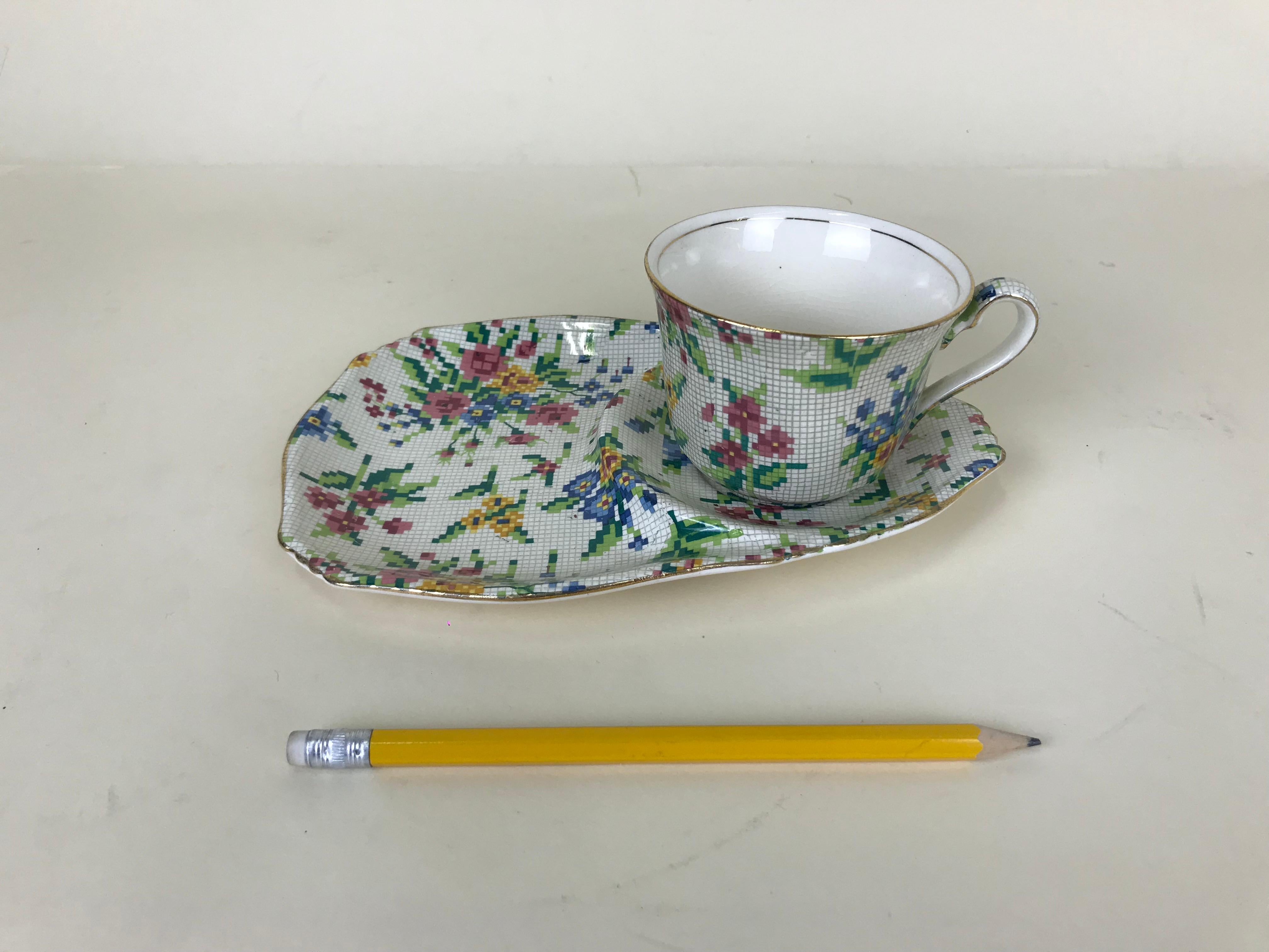 Royal Winton cup and saucer, not restored and ready to be used. The Queen Anne (1936) needlepoint pattern is part of the famed Chintz collection by Royal Winton. It consist of bouquets of flowers in pink, blue and yellow, accompanied by green leaves