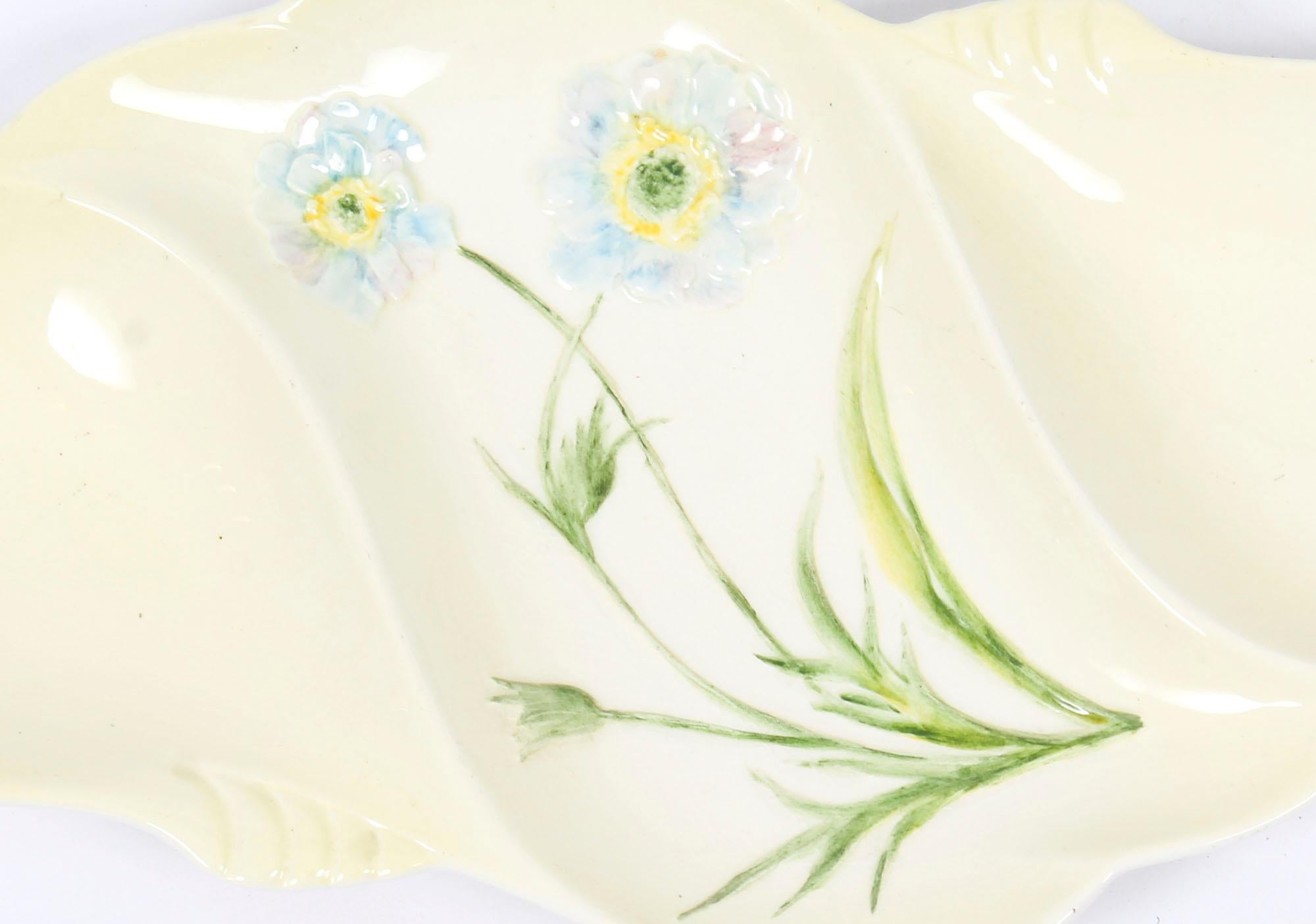 This is a beautiful English Art Deco Royal Winton Grimwade Cosmos snack dish circa 1930 in date.

This plate is elegantly decorated with a pair of flowering Cosmos stems on a banana yellow ground, the underside bears the grey stencilled Royal