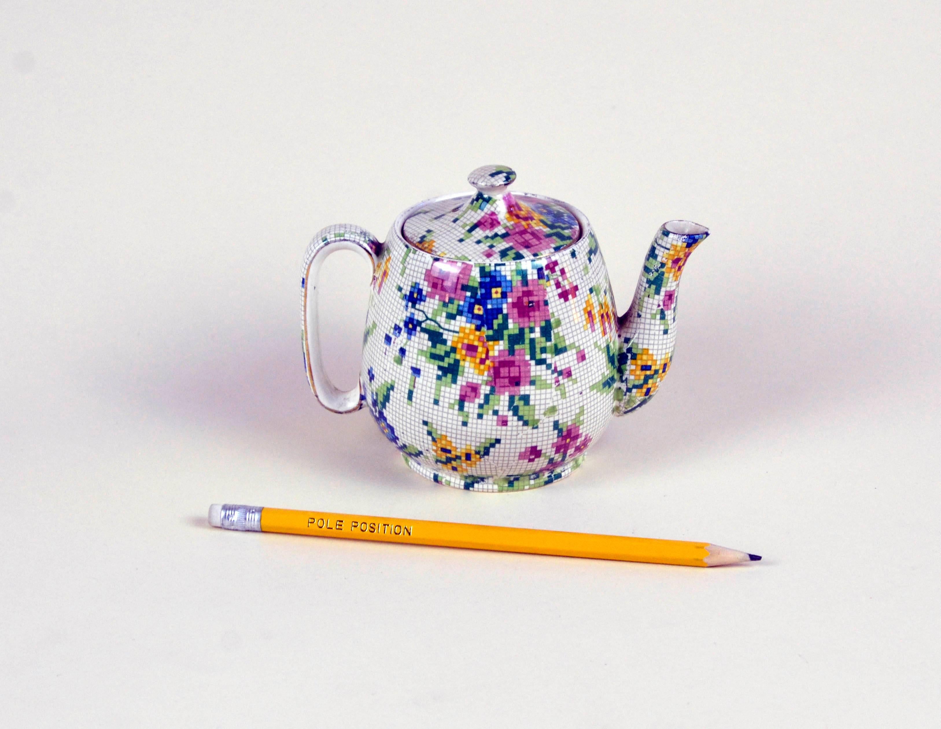 Rare Royal Winton little earthenware teapot in pristine condition, not restored and ready to be used. The Queen Anne (1936) needlepoint pattern is part of the famed Chintz collection by Royal Winton. It consist of bouquets of flowers in pink, blue