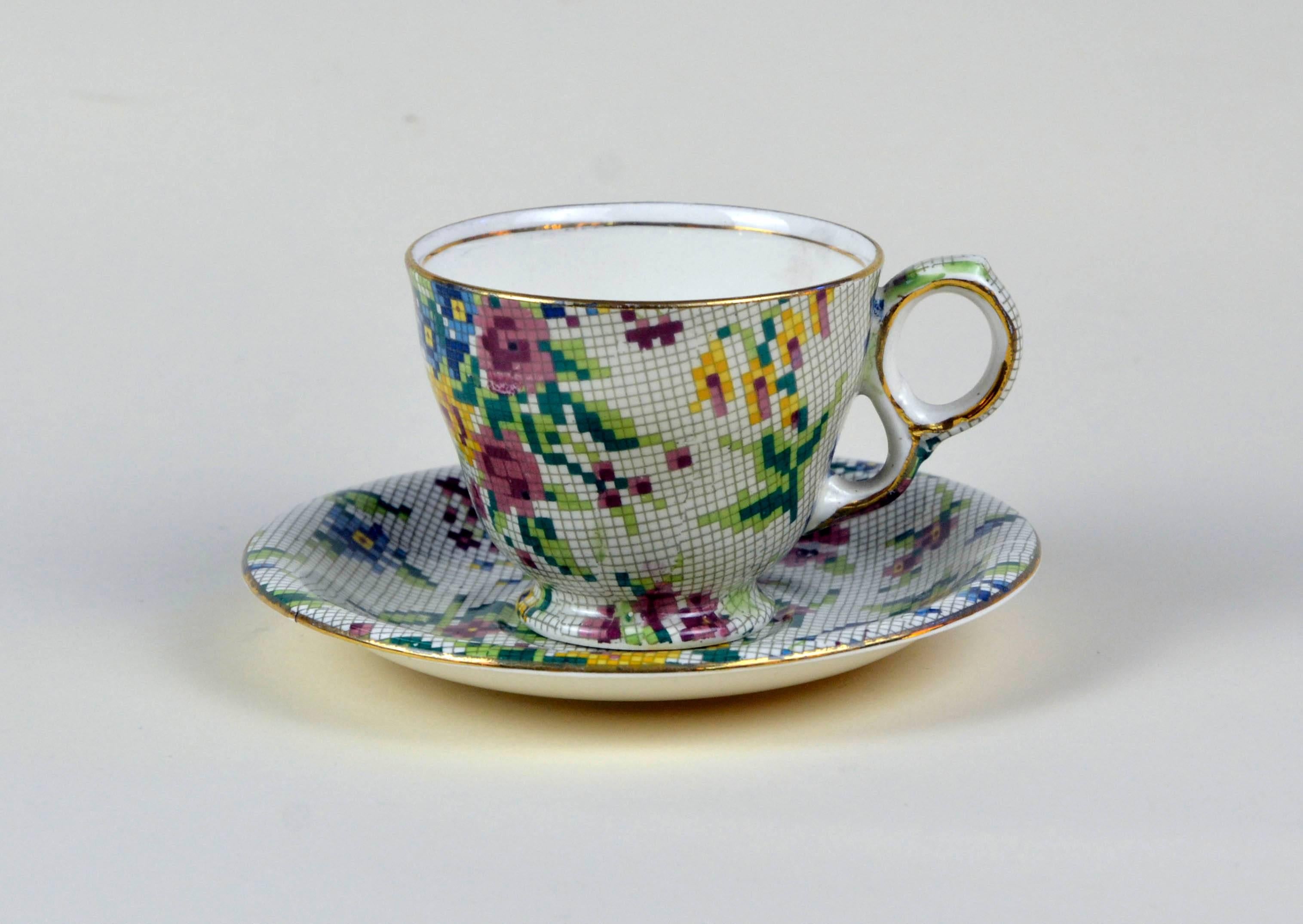 Pair of two Royal Winton earthenware tea cups in pristine condition, not restored and ready to be used. The Queen Anne (1936) needlepoint pattern is part of the famed Chintz collection by Royal Winton. It consist of bouquets of flowers in pink, blue