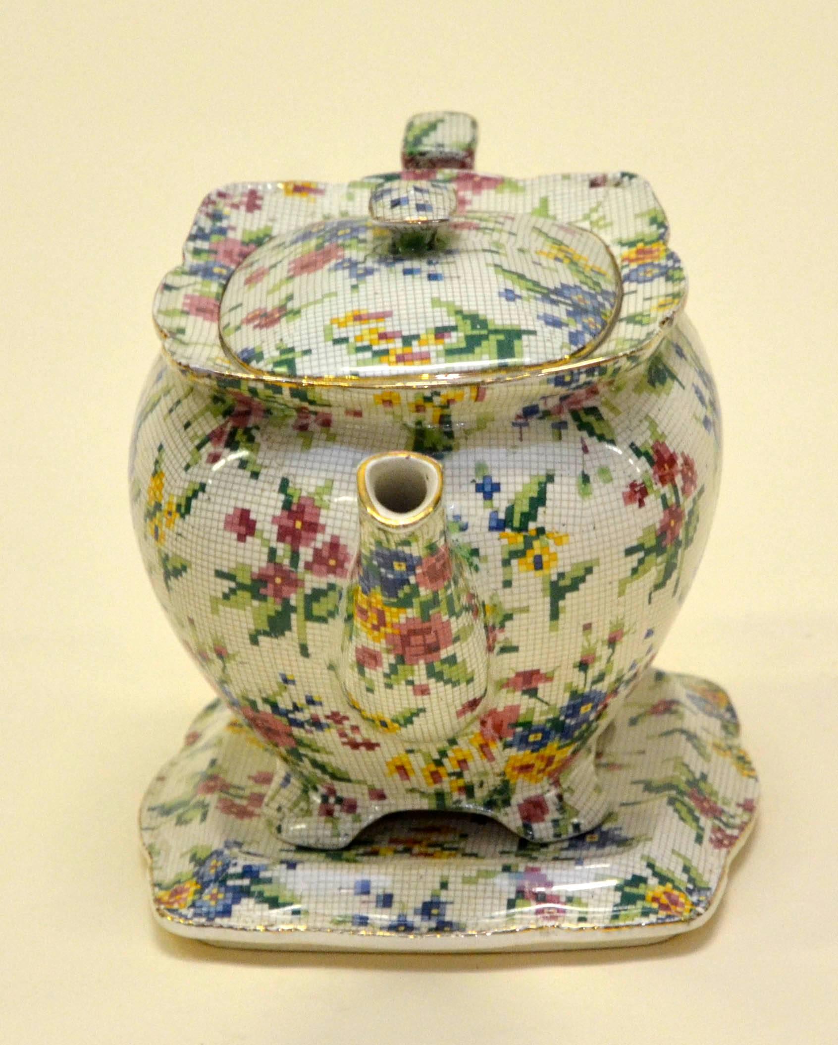 Rare Royal Winton earthenware teapot in pristine condition, not restored and ready to be used. The Queen Anne (1936) needlepoint pattern is part of the famed Chintz collection by Royal Winton. It consist of bouquets of flowers in pink, blue and