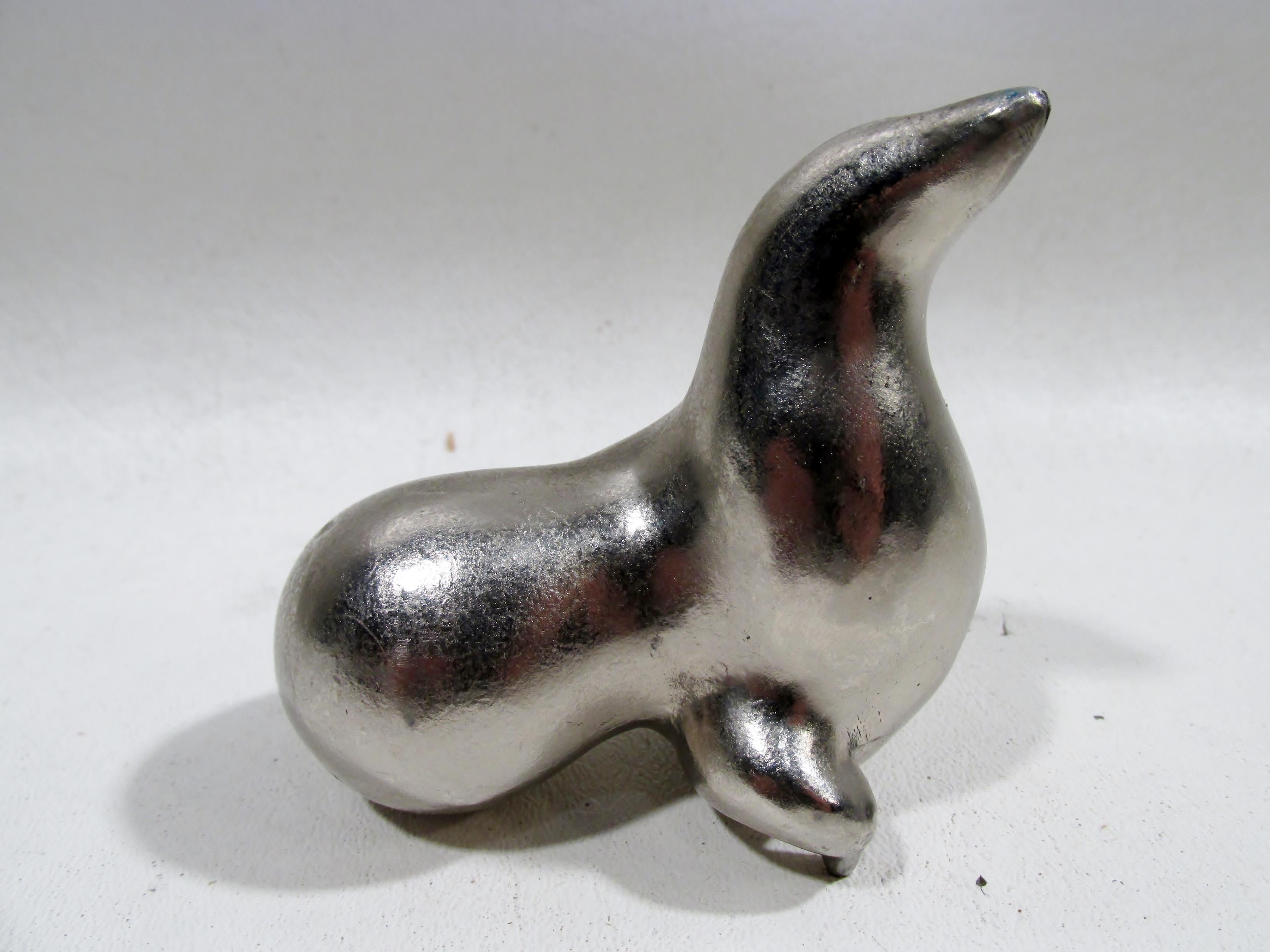 A scarce and rarely seen original Art Deco “Whoozoo” chromium plated steel seal paperweight designed and produced by Russel Wright in the 1930s as part of a series of whimsical circus animals. Signed to side “RW” and approx. 2 7/8” tall, 3 1/8” long