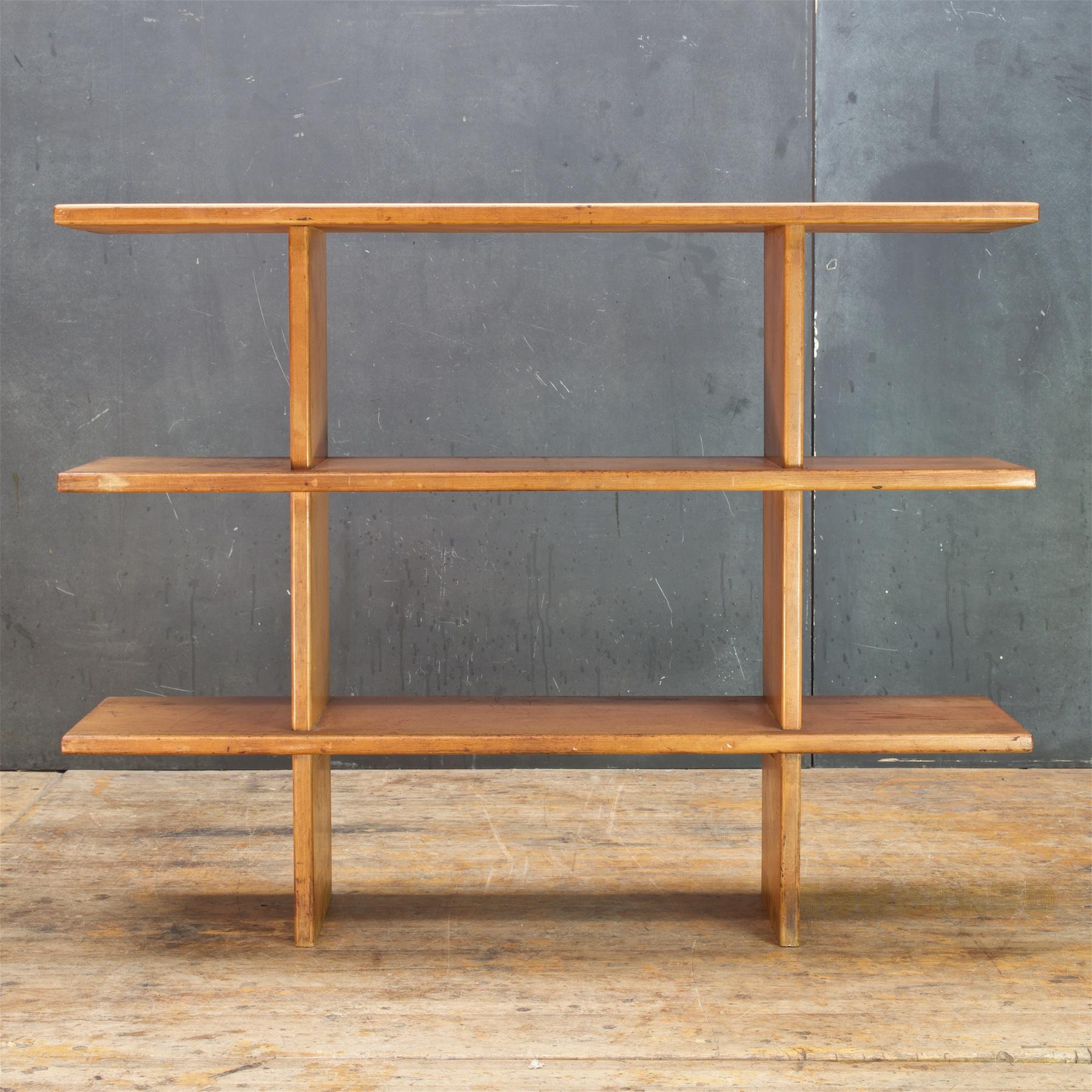 Versatile and sculptural piece of shelving. Presented in original finish, time worn patina. Measures: Shelf heights are 9, 19.5 and 30 inches.