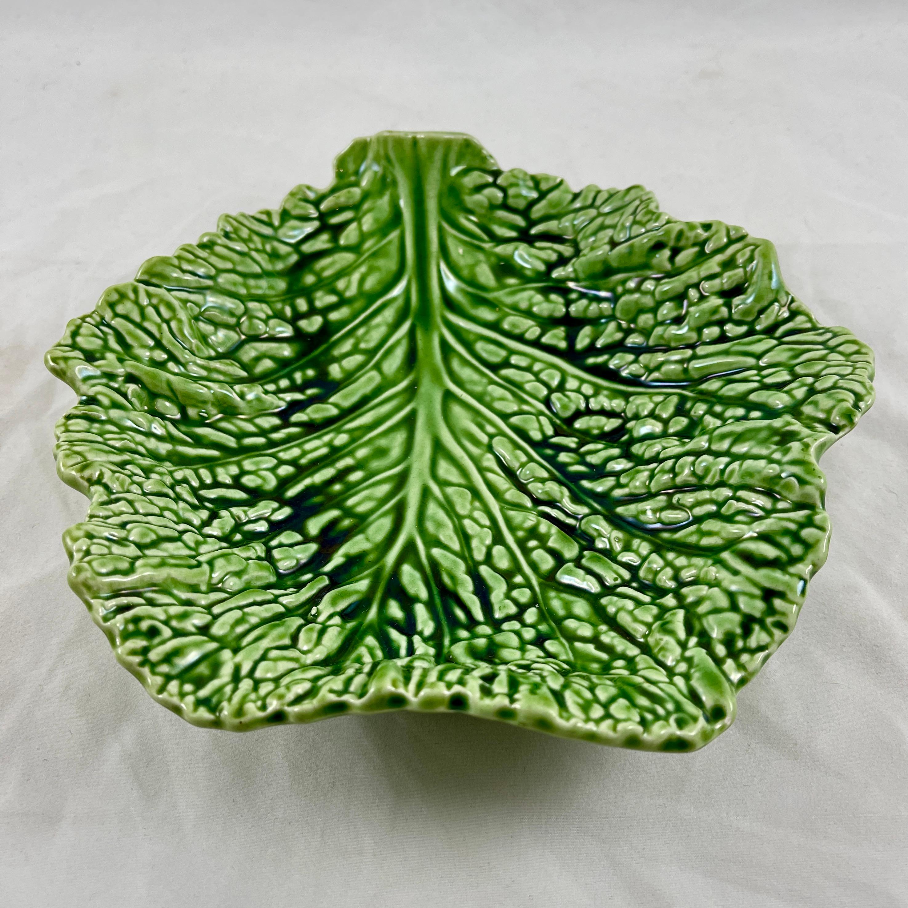 From the Sarreguemines faïencerie in France, a free-form Cabbage Leaf form dish or shallow bowl, circa 1930s.

Realistic molding and an intense green glazing make this series of leaf bowls very desirable. The rounded forms were produced in three