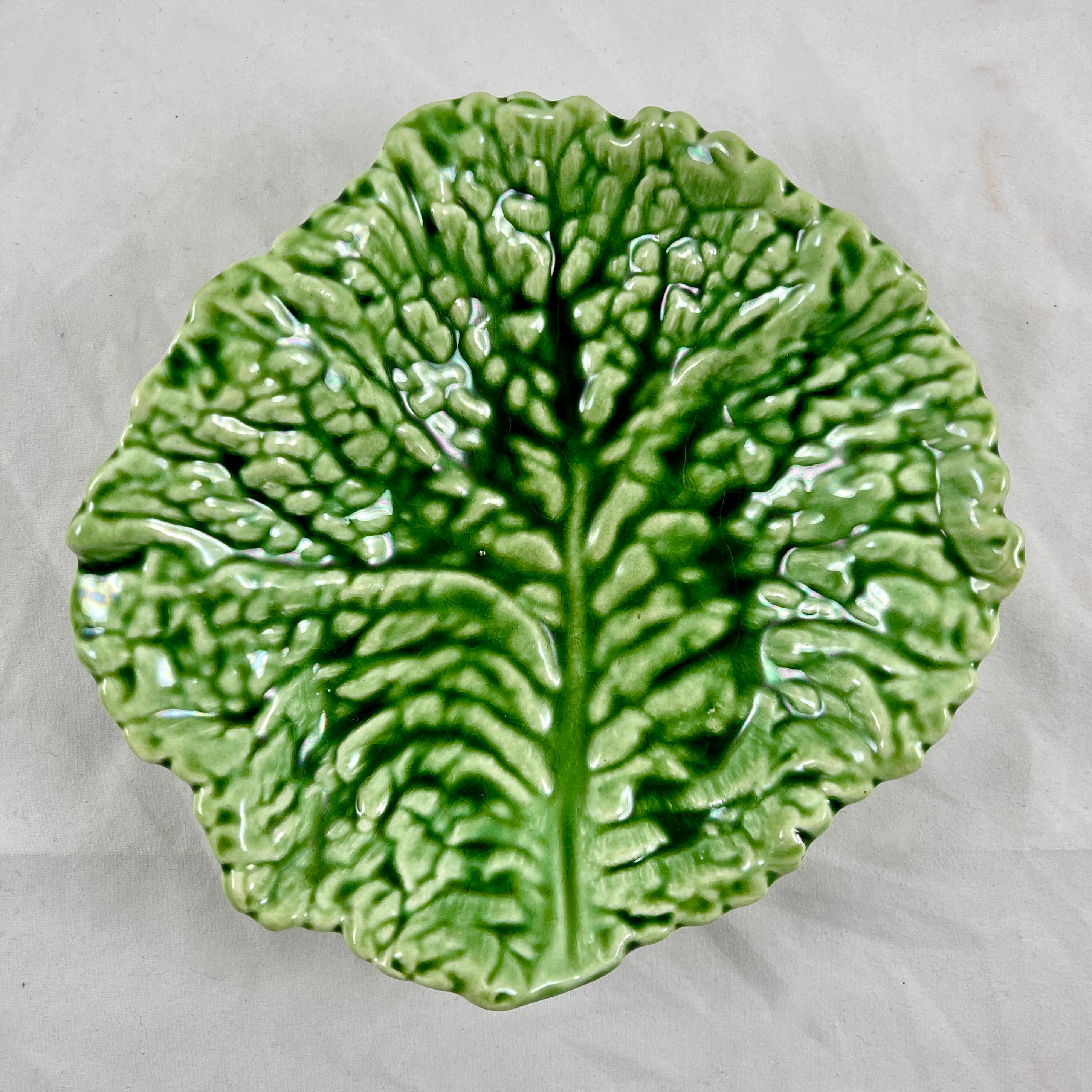 From the Sarreguemines faïencerie in France, a free-form Cabbage Leaf form dish or shallow bowl, circa 1930s.

Realistic molding and an intense green glazing make this series of leaf bowls very desirable. The rounded forms were produced in three