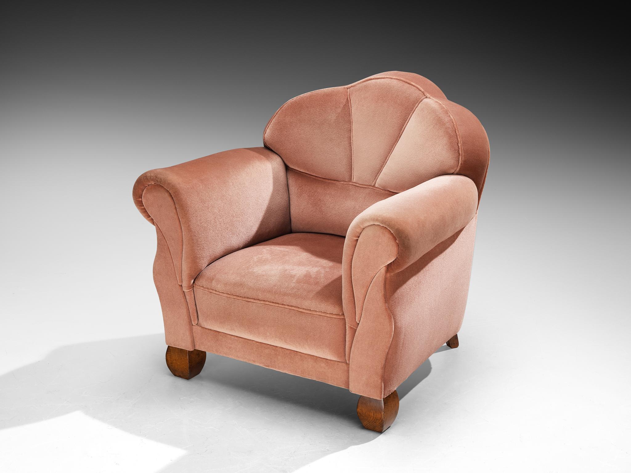 Lounge chair, velvet, oak, Europe, 1930s

A beautiful example of the Art Deco period, this lounge chair dates from the 1930s, executed in a lovely dusty pink velvety fabric. This piece is resting on solid oak legs, its robust base provides a warm