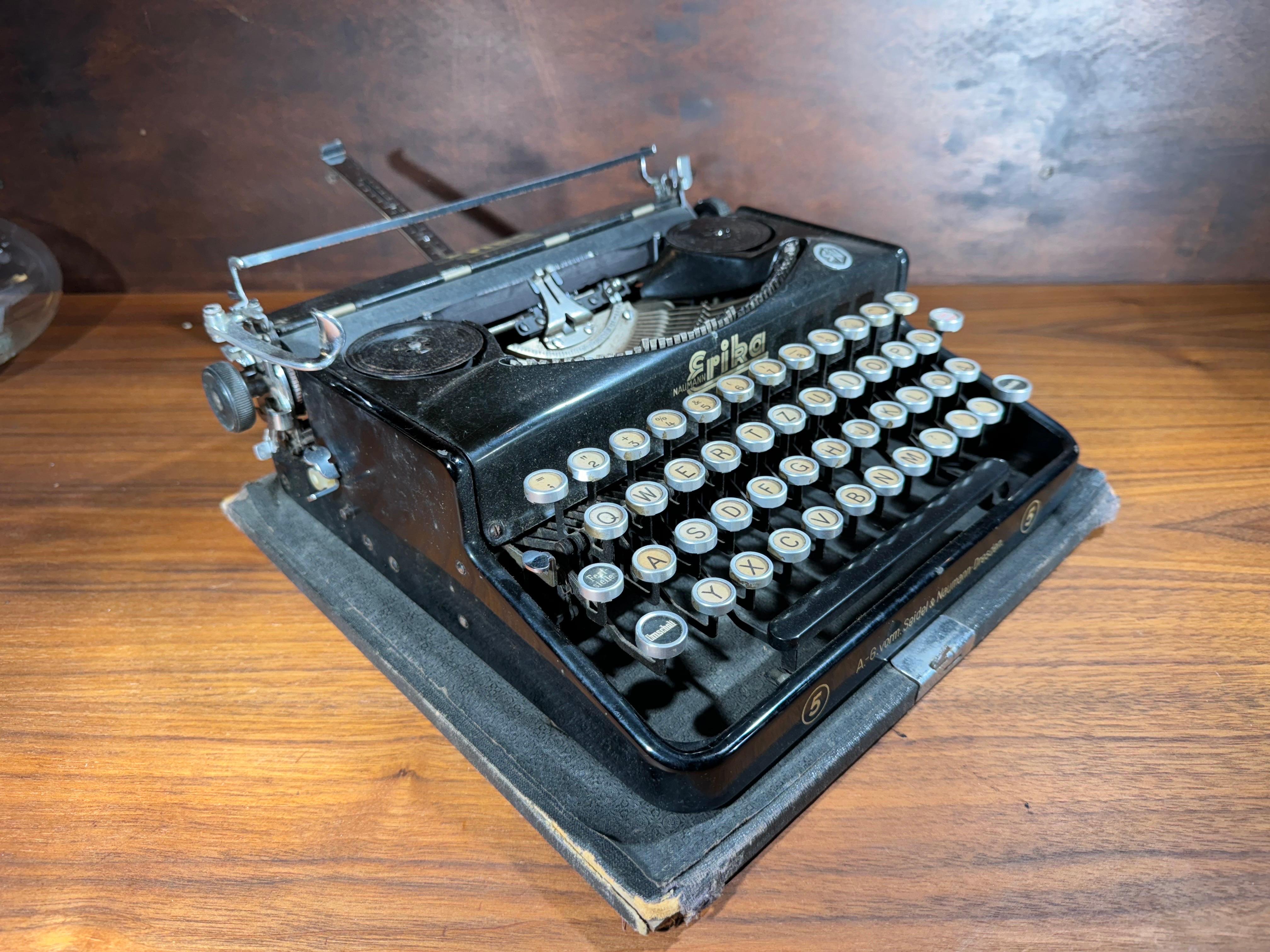 Gorgeous 1930's industrial portable typewriter made in Dresden, Germany by Seidel & Neumann. This Erika Model 5 typewriter is a stunner and comes complete with its original wood and leather carrying case. The letters on the keyboard indicate its an