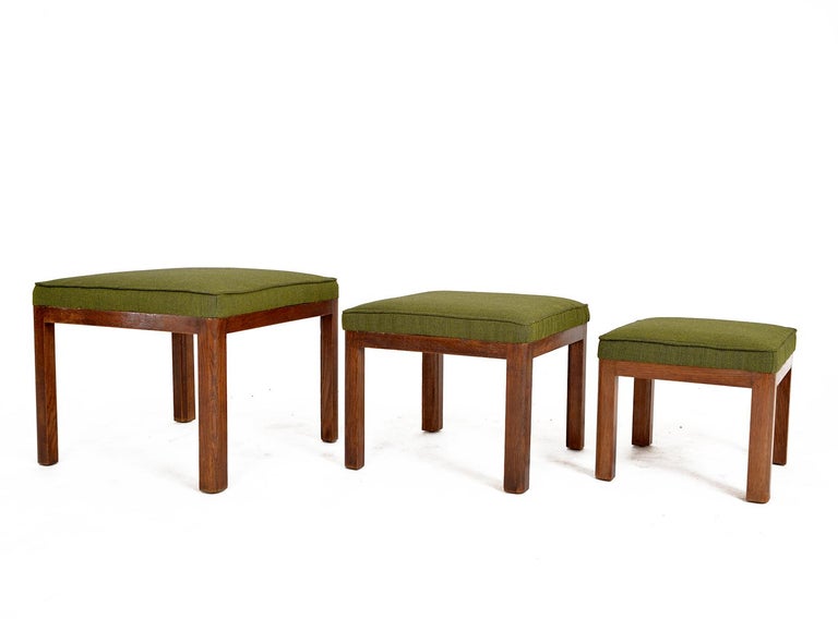 A rare nest of three 1930s Parker Knoll oak nesting stools - The “Frant” PK 569 - newly upholstered in green Kvadrat fabric. Stamped marks to the underside of each stool inscribed: ‘Registered Parker-Knoll Trademark patent No 322638’. An incredibly
