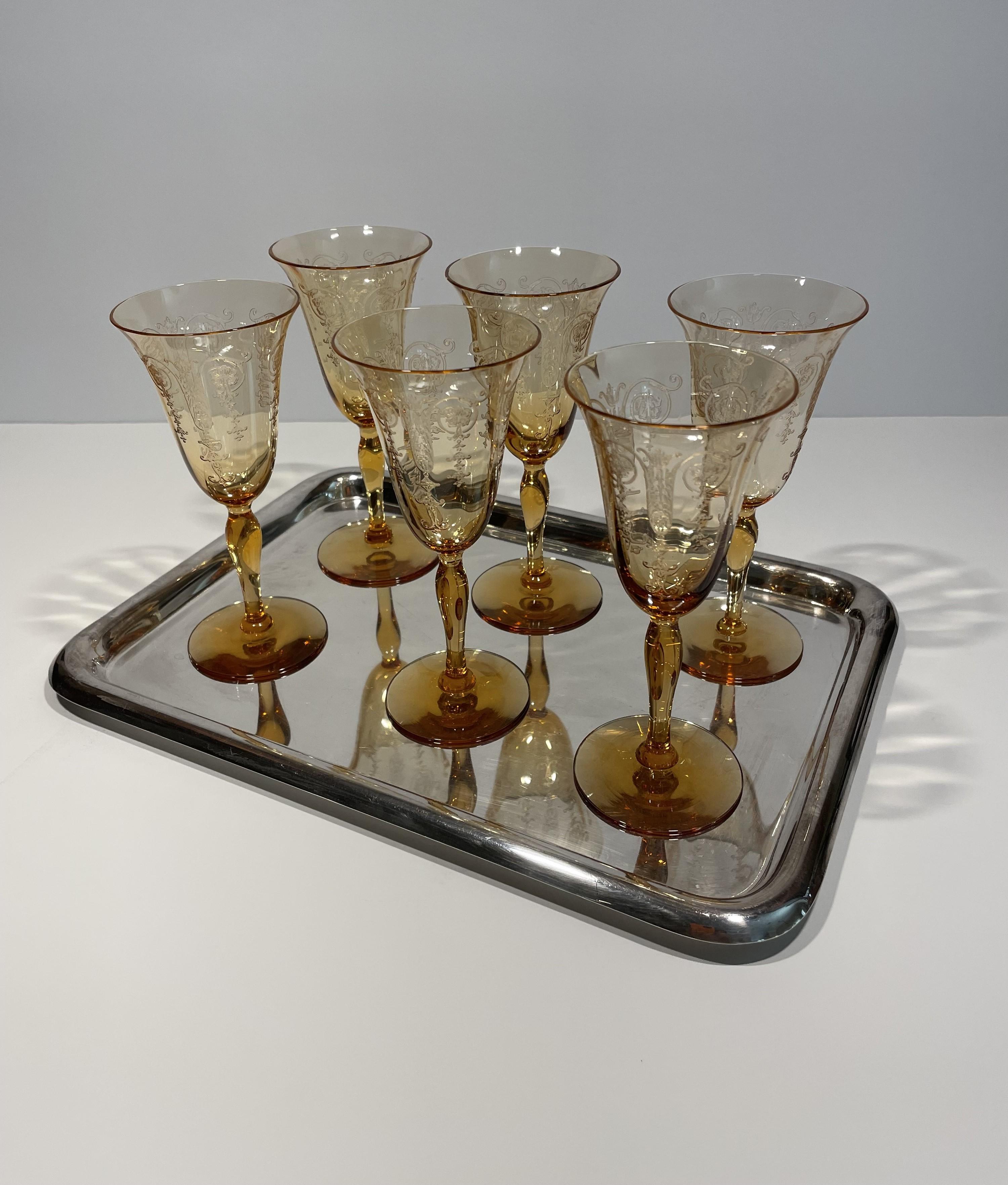 This set of etched French crystal liqueur glasses, which dates to the 1930s, is in mint condition. The subtle amber color of the glasses will enhance the color of your drinks nicely. I have curated this set of vintage glasses with a very mid-century