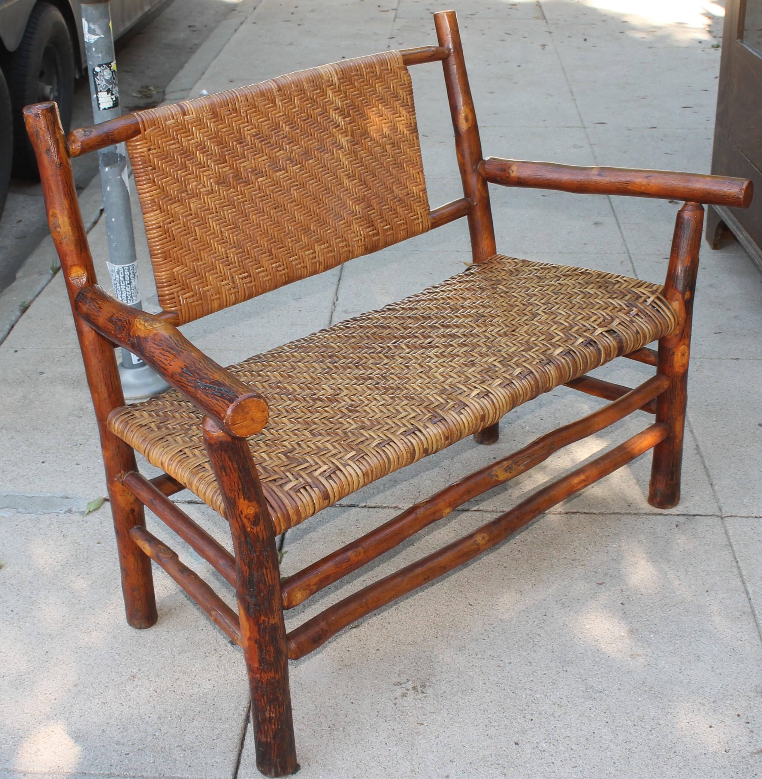 This comfortable signed Old Hickory Furniture settee/bench is in amazing condition. The bench has such a wonderful old patina. This settees are so hard to find in such pristine condition.