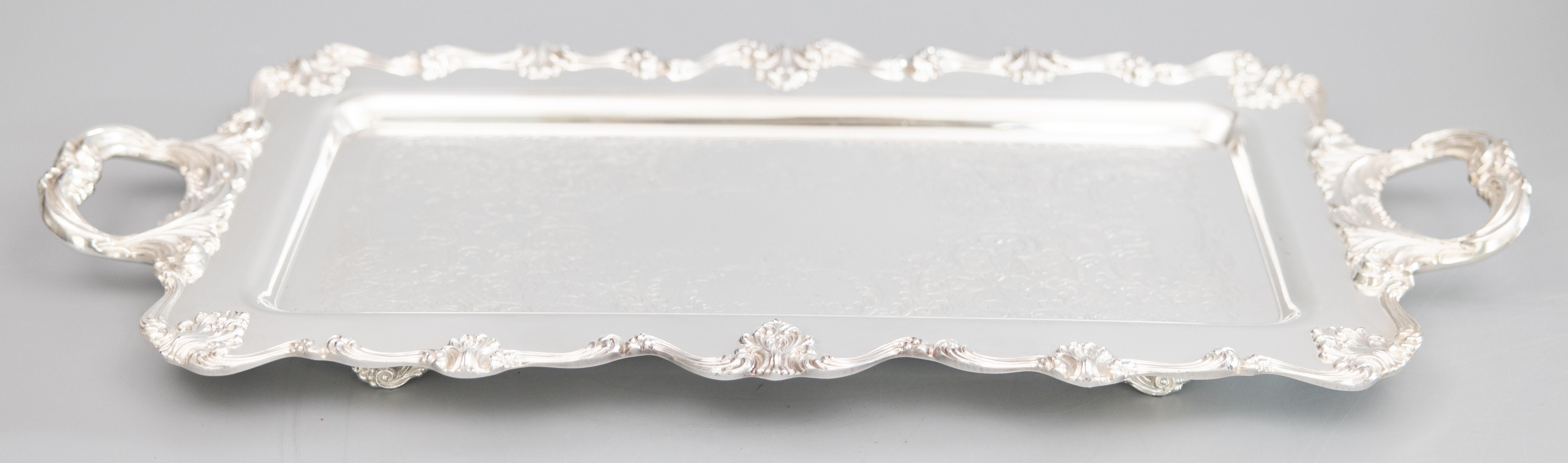 A fine vintage 1930s silverplate footed serving or barware tray with handles by W&S Blackinton. Maker's mark on reverse. This gorgeous tray is large and heavy, weighing over 7 lbs, with lovely floral etching and an ornate decorative border and shell