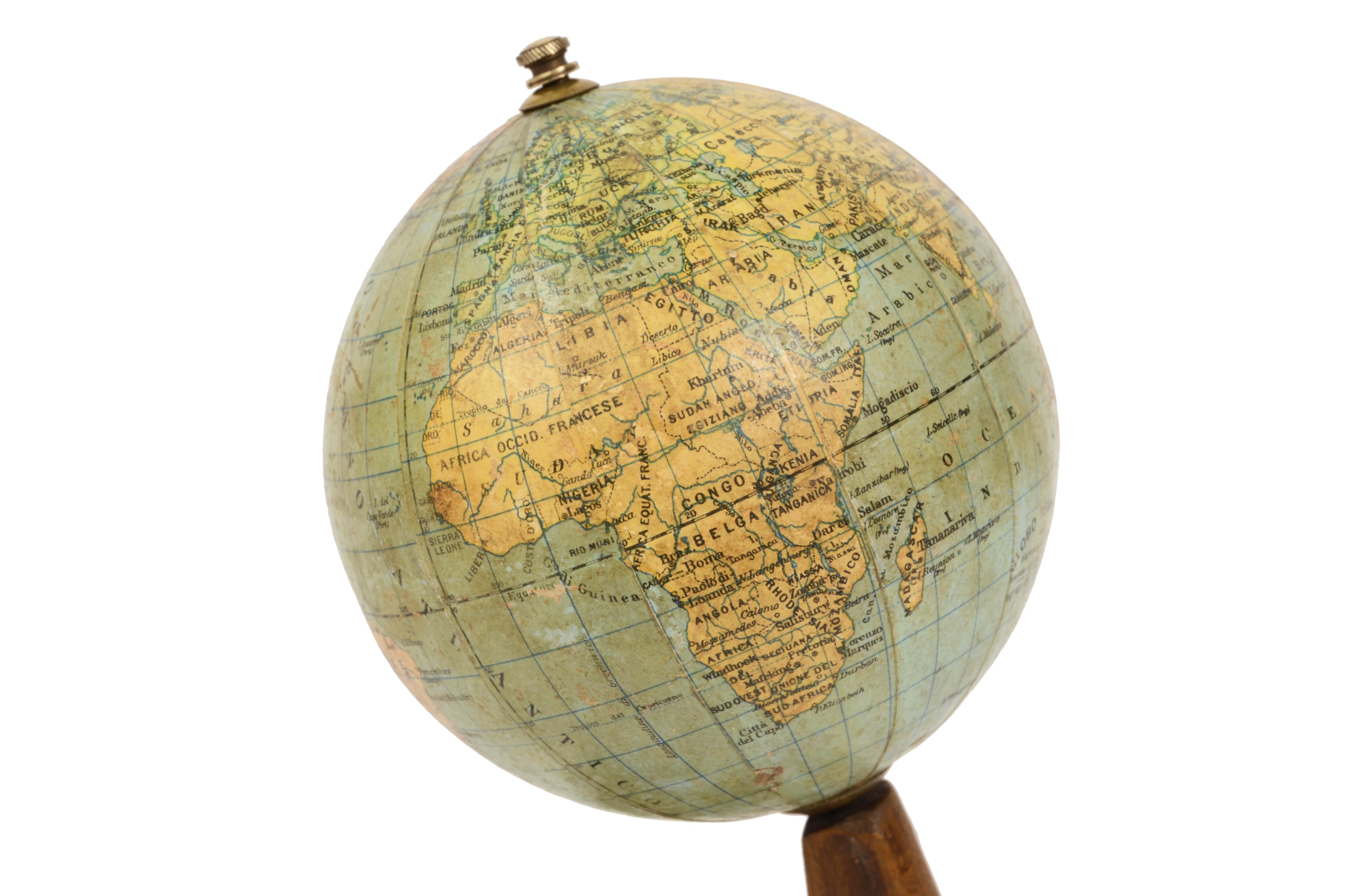 Small and rare terrestrial globe by Vallardi in Milan publisher designed by and engraved by A. Minelli in the thirties. 
Wooden base and papier-mâché sphere. 
Measures: height 19 cm, inches 7.5, sphere diameter 10 cm., inches 3.95. Good