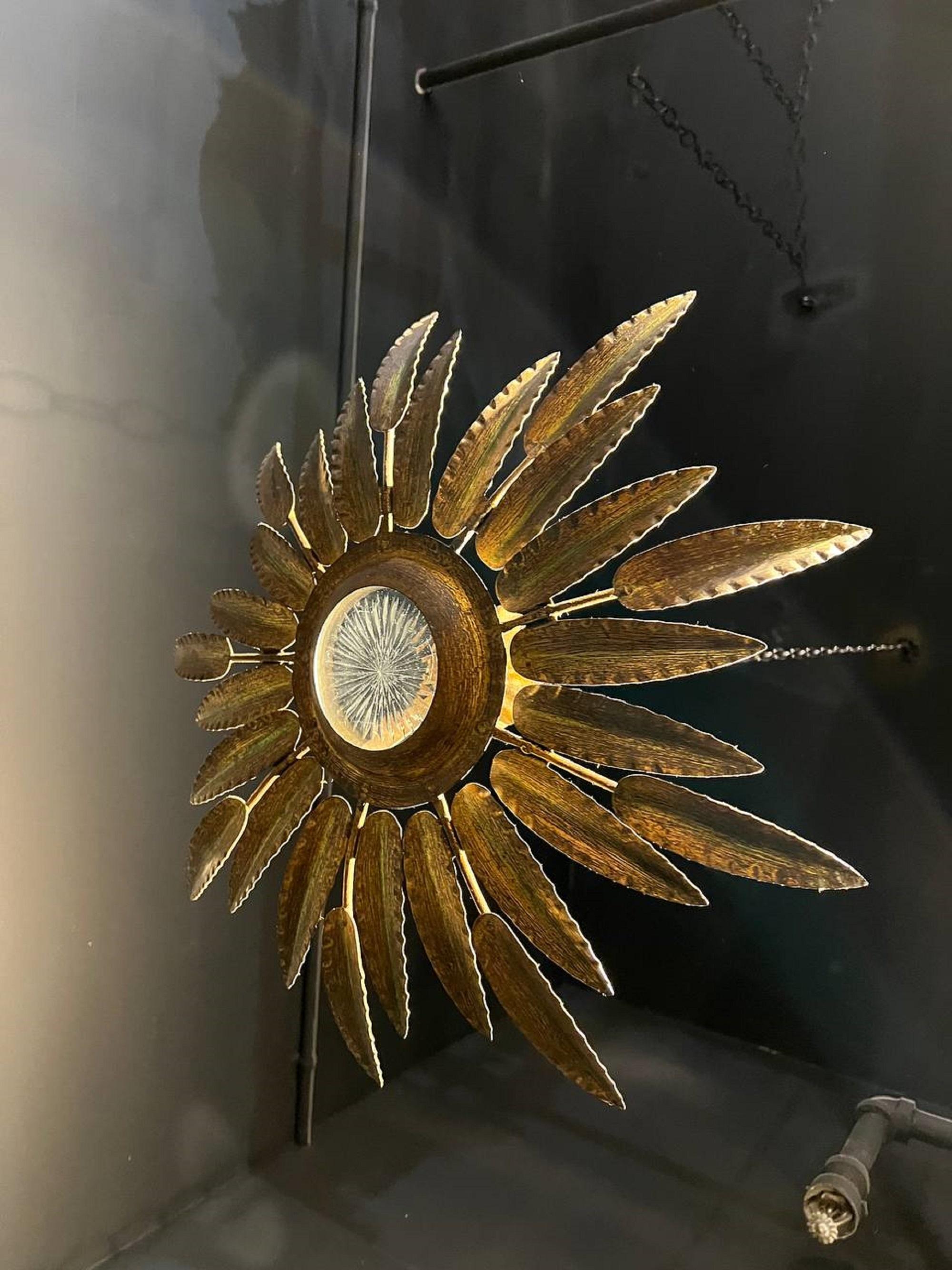 Circa 1930’s French gilt metal sunburst light fixture with interior lights and cut glass inset 