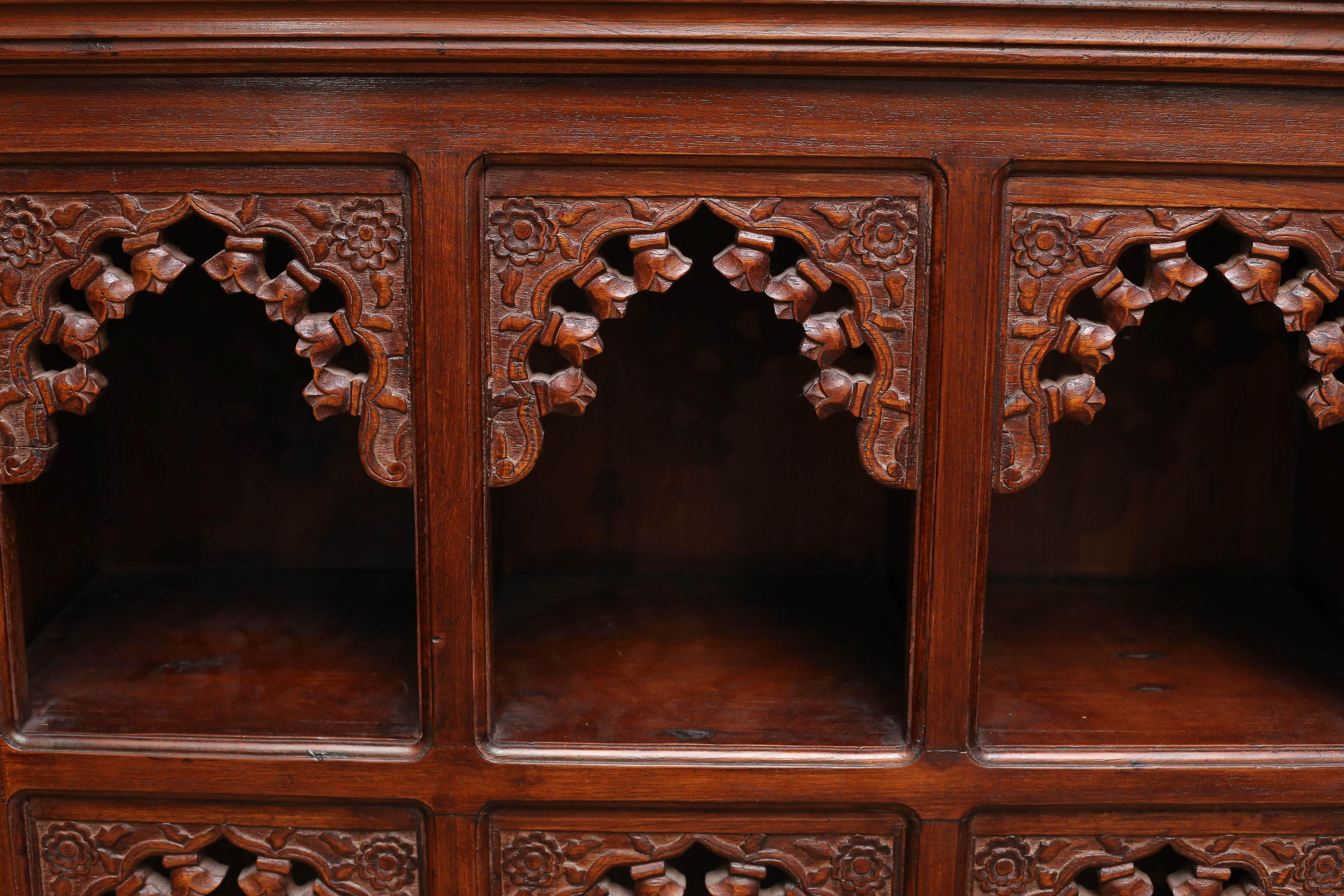 This heavily carved solid teak wood children bookcase comes from a Montssorie school in the hill station town of Darjeeling. It is finely crafted with nine compartments for keeping different types of children books. This elegant piece of furniture