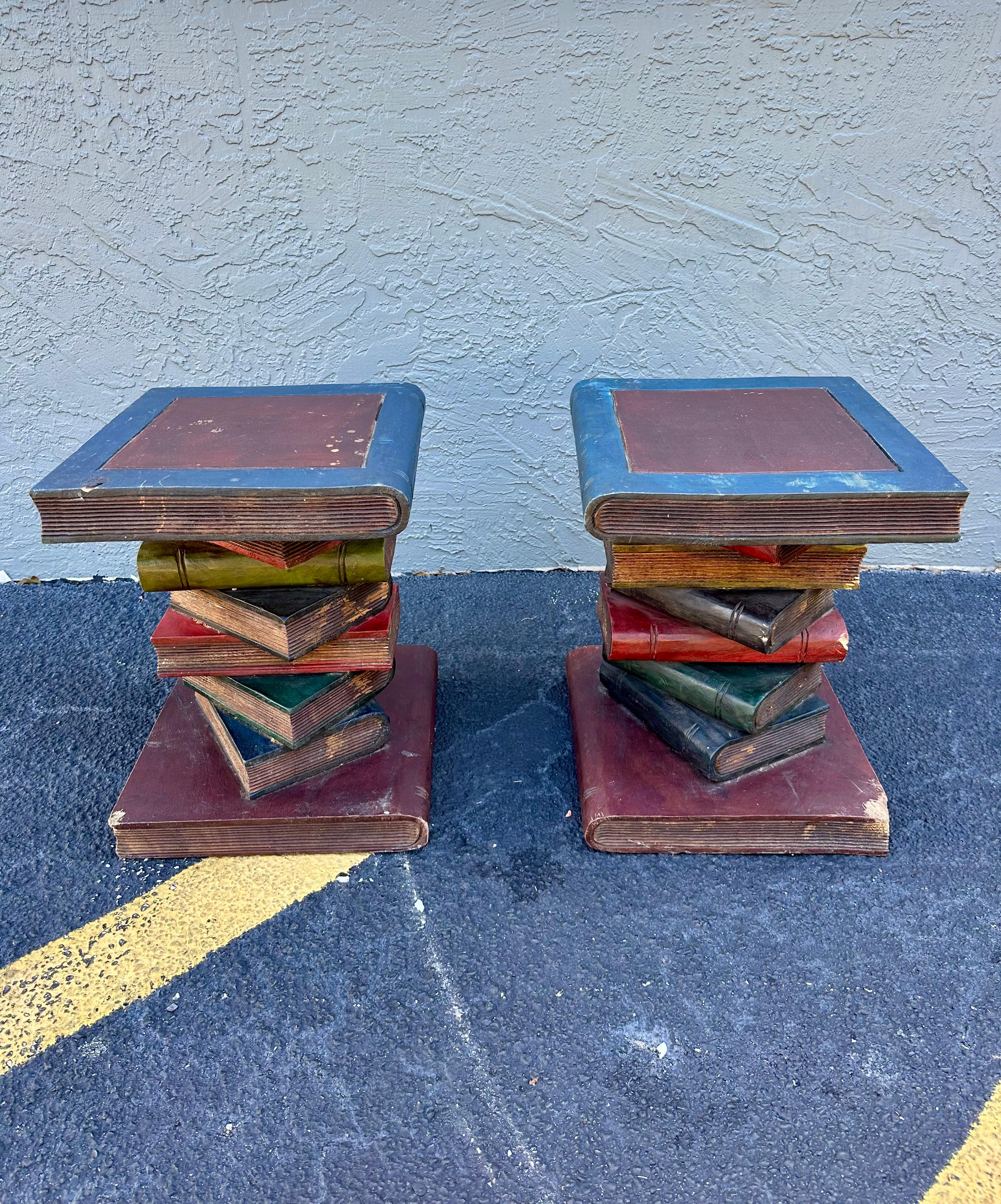 This charming side tables featuring painted faux books in a realistic form with each book showing texture and great patina. Each table has been painted in warm tones with gold details. All original. This tables certainly makes a statement and would