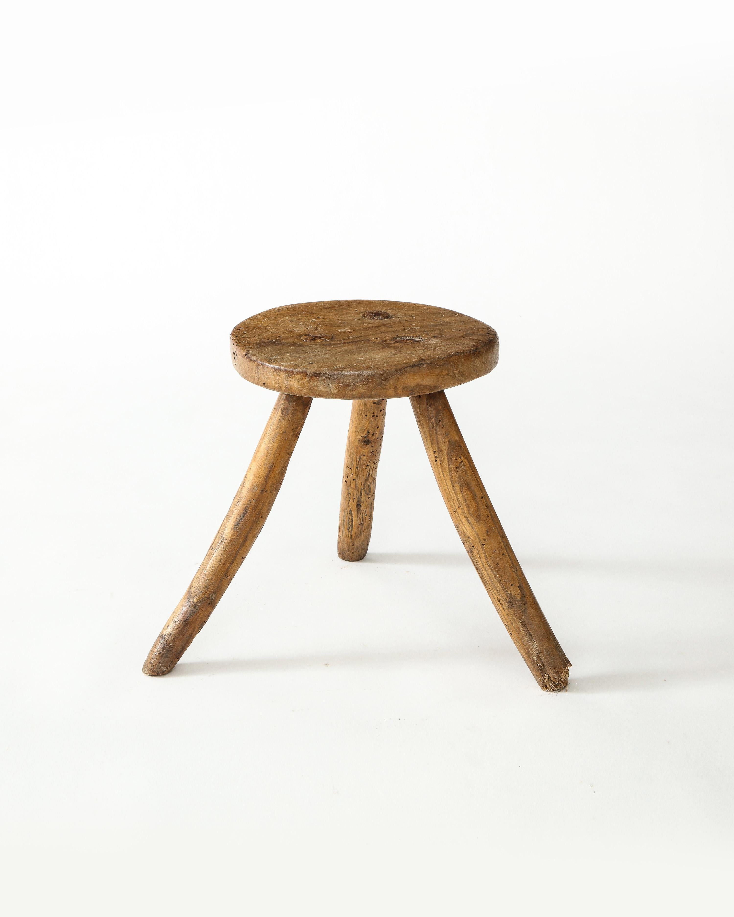 Primitive rustic solid wood three-legged stool, 1930s, Spain. Splayed leg stance.

Great character and patina. Handsome through-tenon detail.

Excellent as a small low side table.