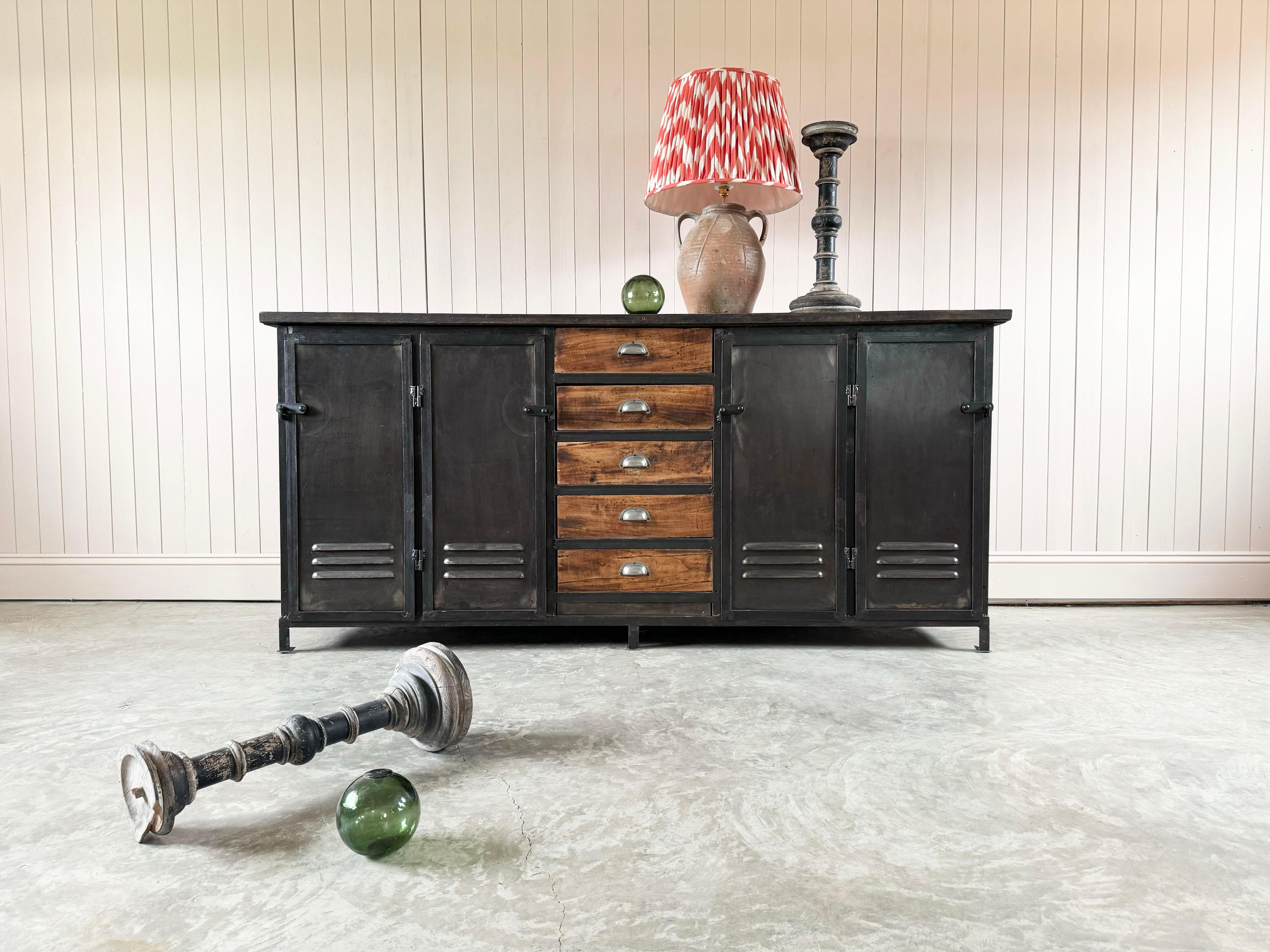 We sourced this Early 20th Century vintage industrial sideboard from a textile factory in Lille, France.

A very chunky factory unit in excellent condition with a few marks to the steel and oak top.  We have added the black painted shelves inside. 