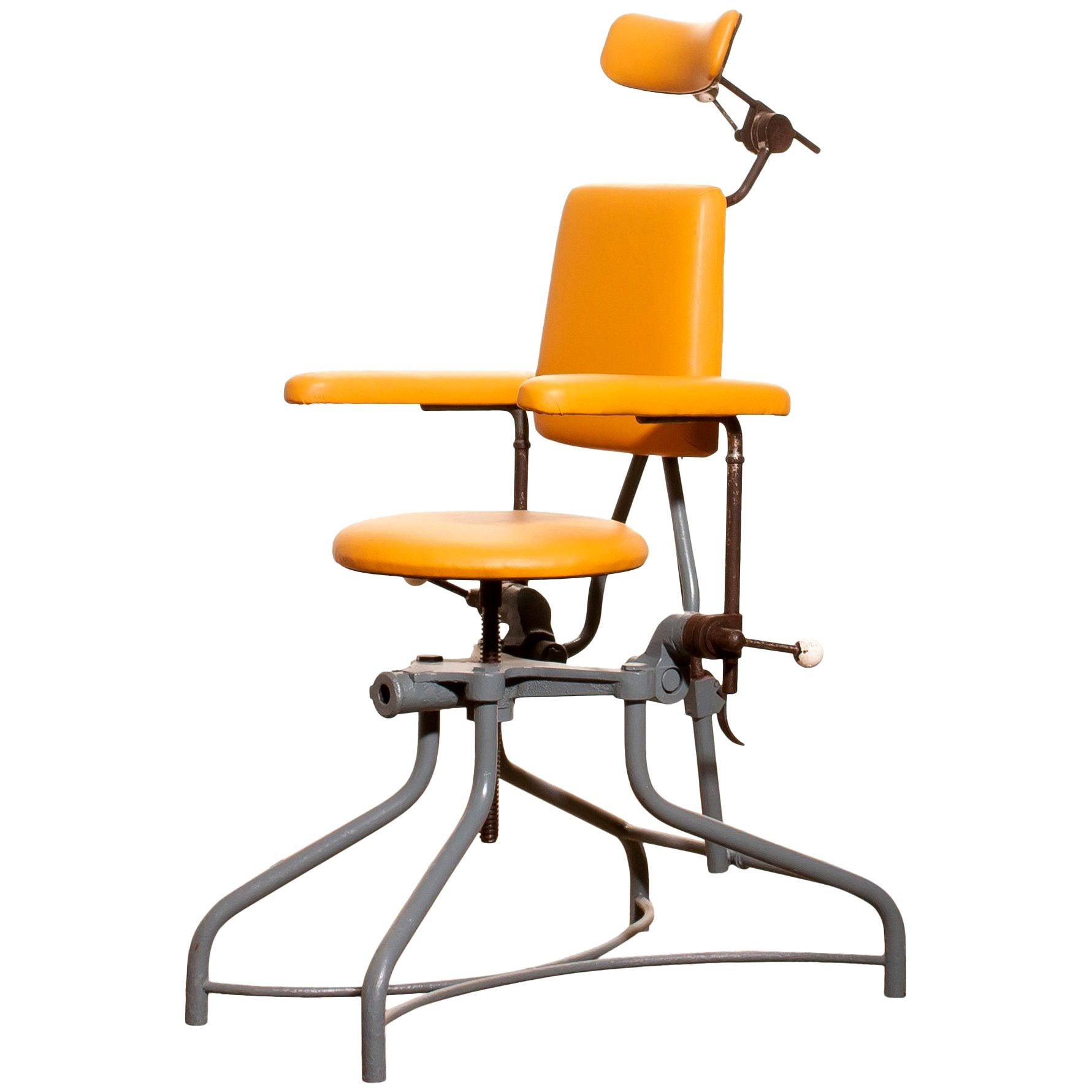 Very nice medical or dentist chair.
The frame is made of grey-blue lacquered steel with a new yellow leatherette seating and neck rest.
The seating and neck rest are adjustable in height.
Some steel parts are rusty what is normal for its