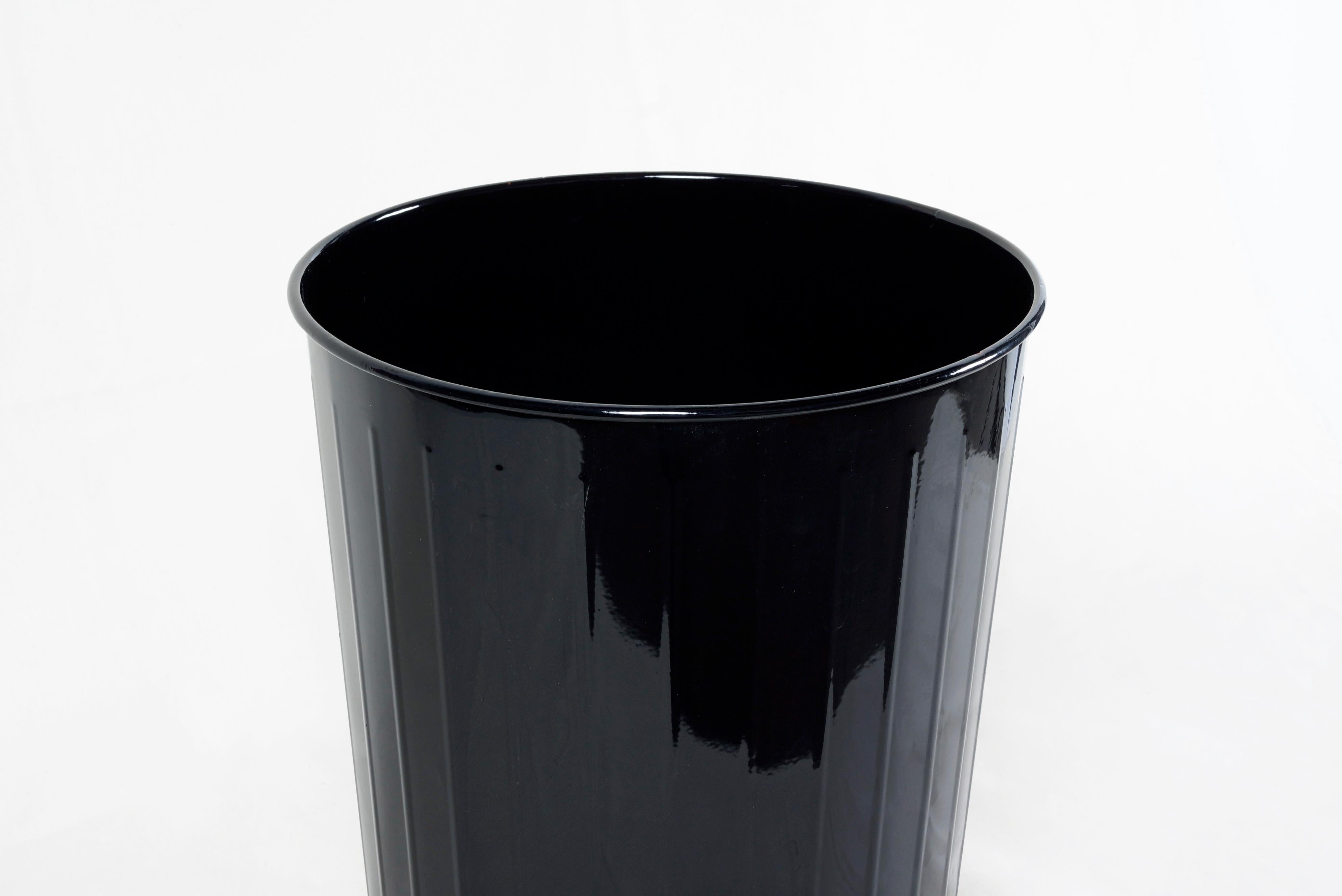 1930s steel waste basket, powder-coated in high-gloss black. An early first design in steel office furniture, the DeWitt waste basket was essential to protect against fires in the new turn-of-the-century high rise buildings. A Classic accessory,