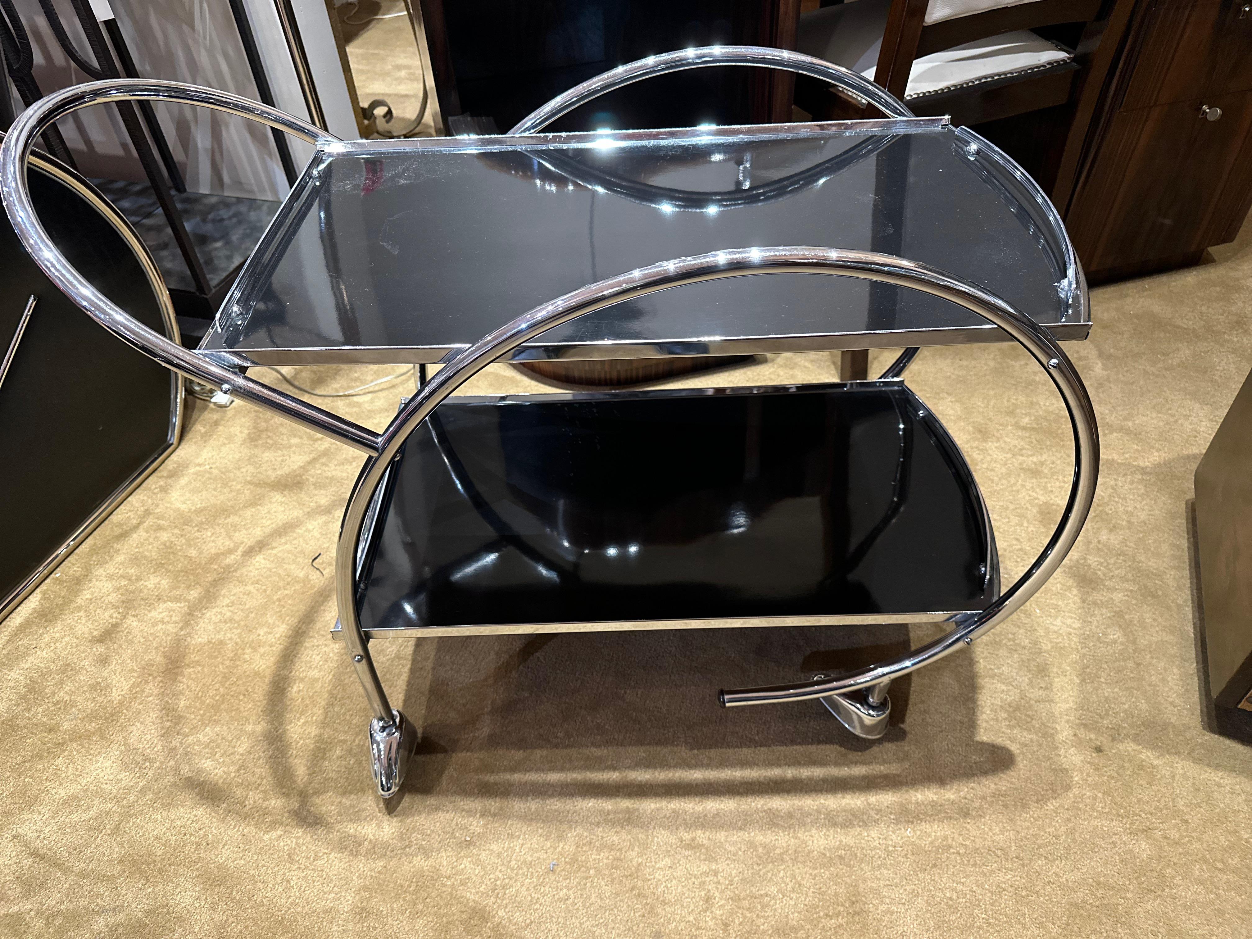 The 1930s Streamline Art Deco Chrome and Glass Hostess Trolley bar cart. This design is a little more unusual in shape than you normally find and is a lot more substantial in weight, quality, and is very sturdy. Can be used for serving drinks, and