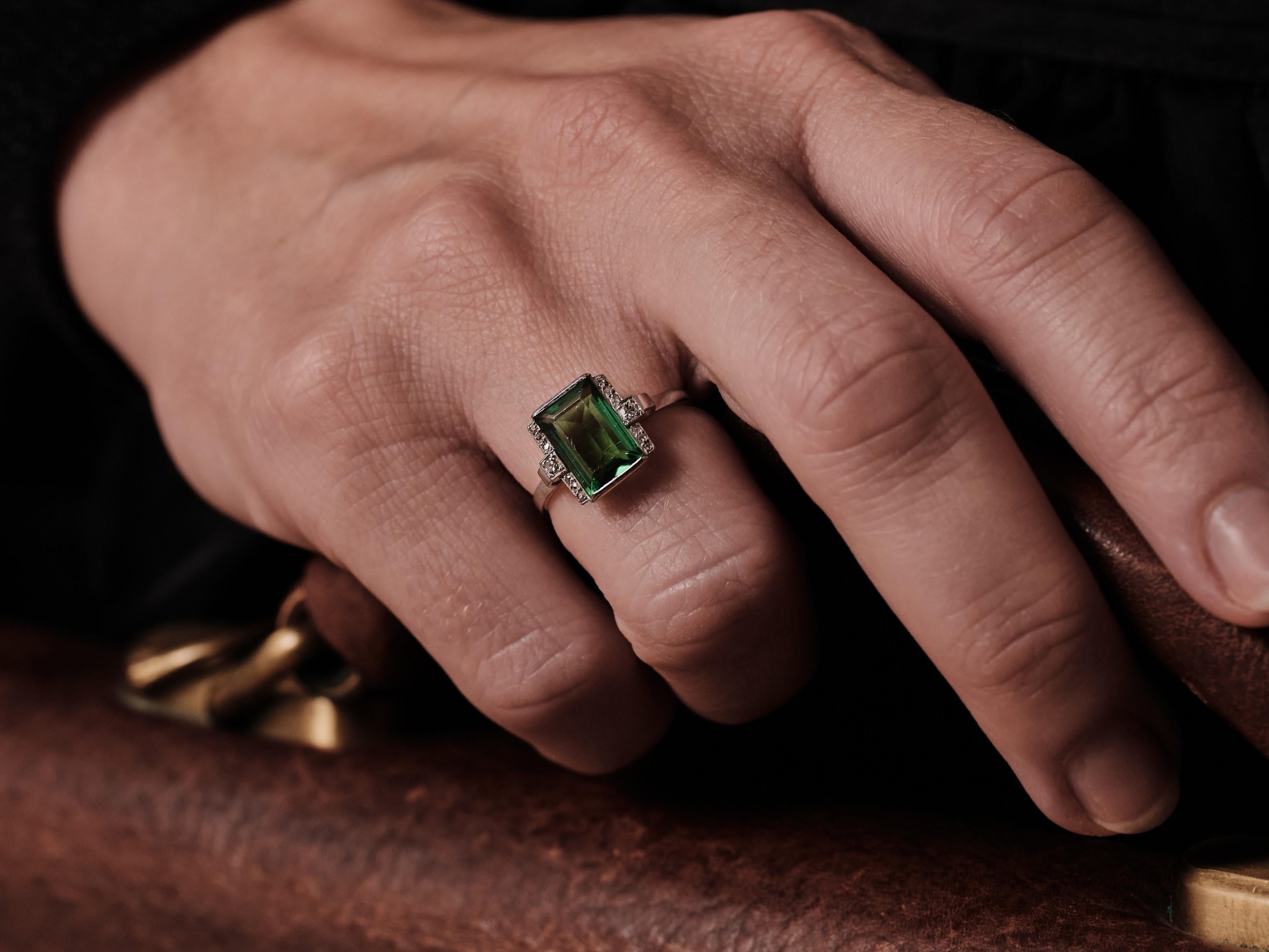 1930s Swedish Grace 2ct Tourmaline ring  

A strict and classic piece that is as modern and contemporary as the day it was made. The green tourmaline, a nice clean saturated stone that measures 9,55 x 7 mm, flanked by 2 x 0,02ct old cut diamonds and