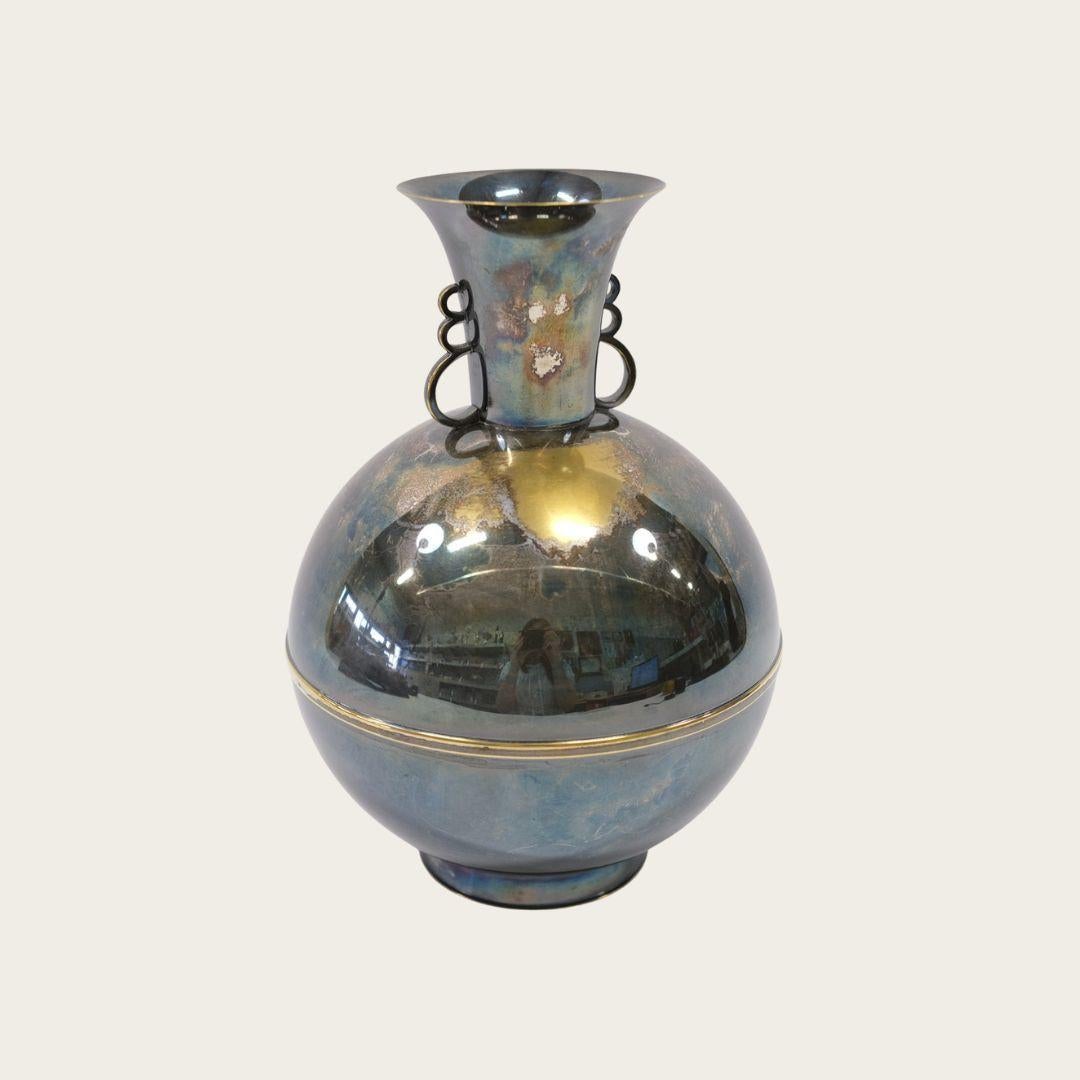 With small scalloped decorative hanger details on both sides, a spherical body and flaring rim.