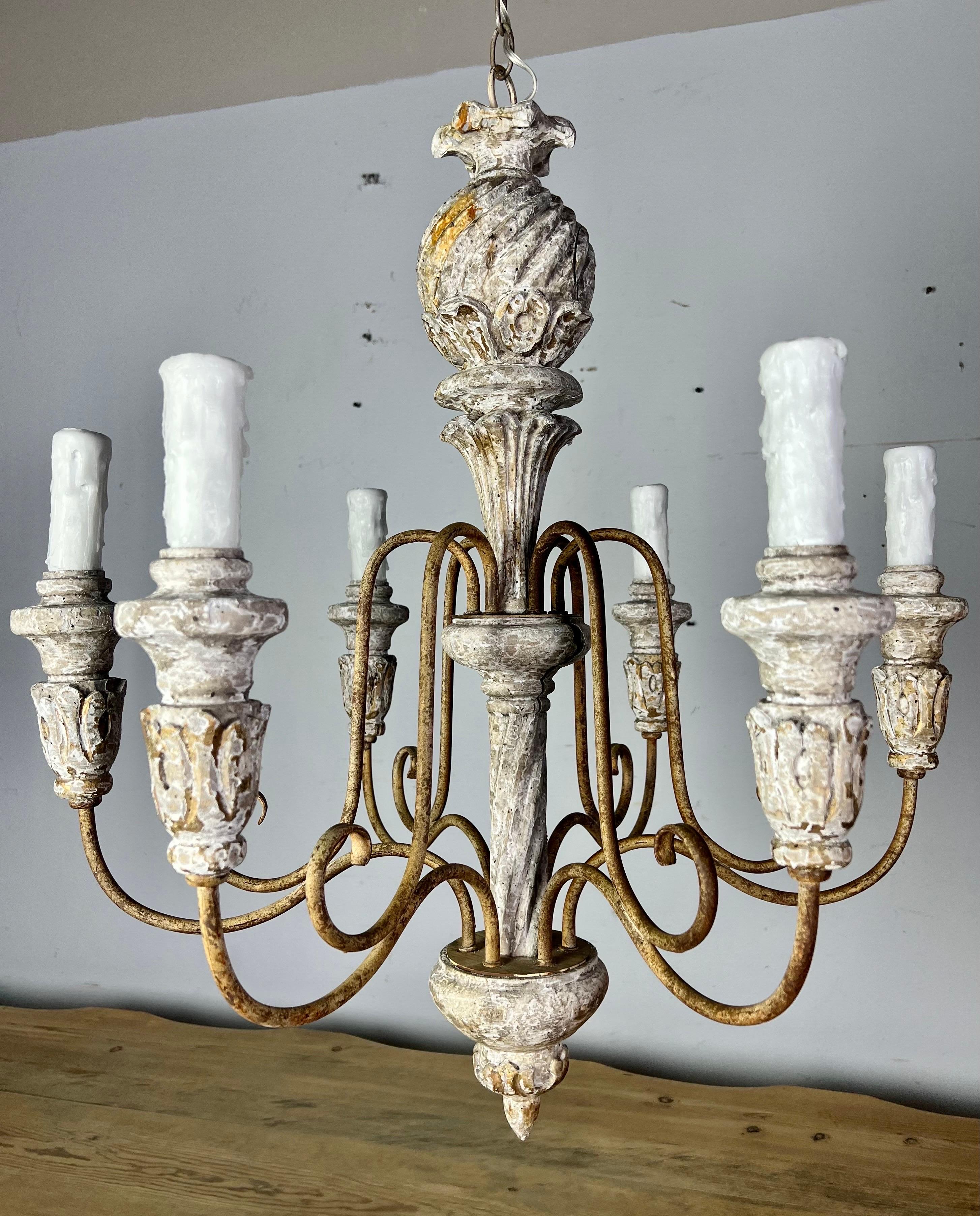 6-light 1930s Swedish wood carved chandelier. The chandelier is painted in a distressed creamy grayish coloration. The fixture has six iron arms. It is newly rewired with drip wax candle covers. Includes chain & canopy.