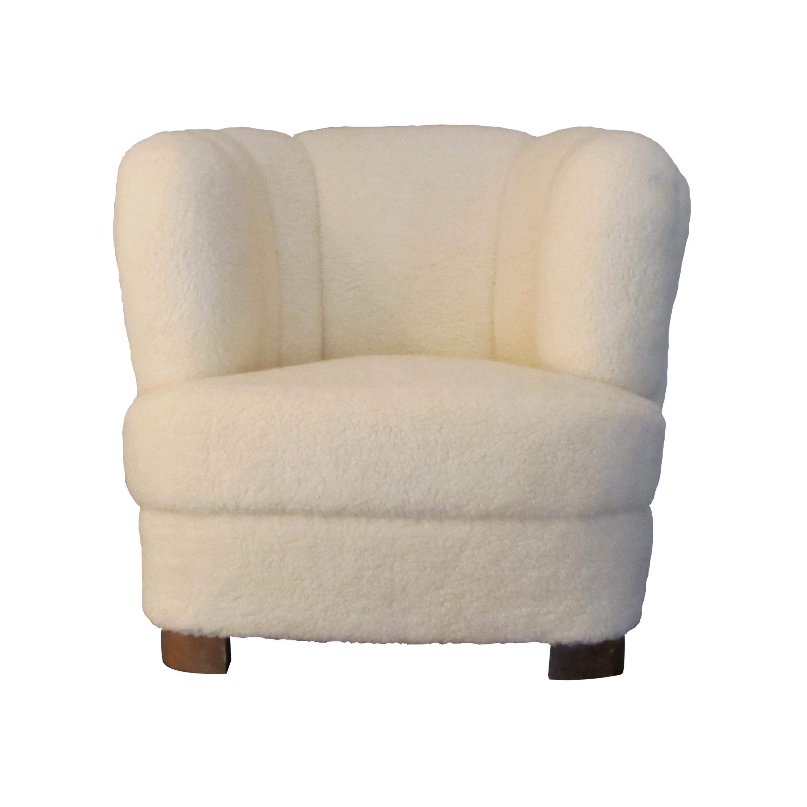 1930s Swedish single club armchair reupholstered in a lambskin fabric mix. The fabric is really soft and has a luxurious feel to it. This snug Art Deco armchair is well-padded and is very comfortable. The armchair would be a perfect addition in most