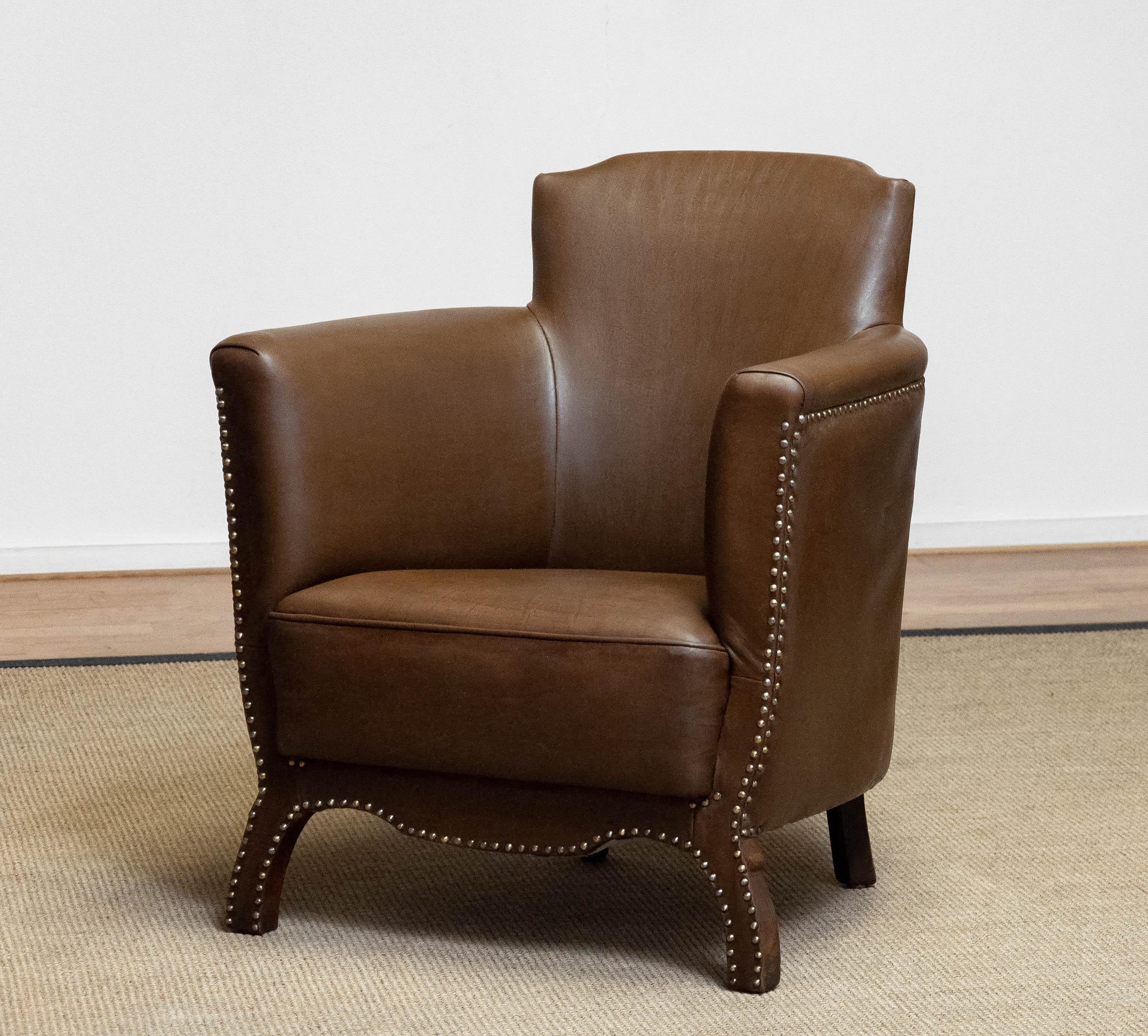 Beautiful brown / tan nailed leather lounge chair from the 1930s designed by Otto Schultz for Boet Götenburg Sweden. This lounge chair in in a later period ( in the 1990s ) fully restored and therefor in very good condition. Sits and supports great