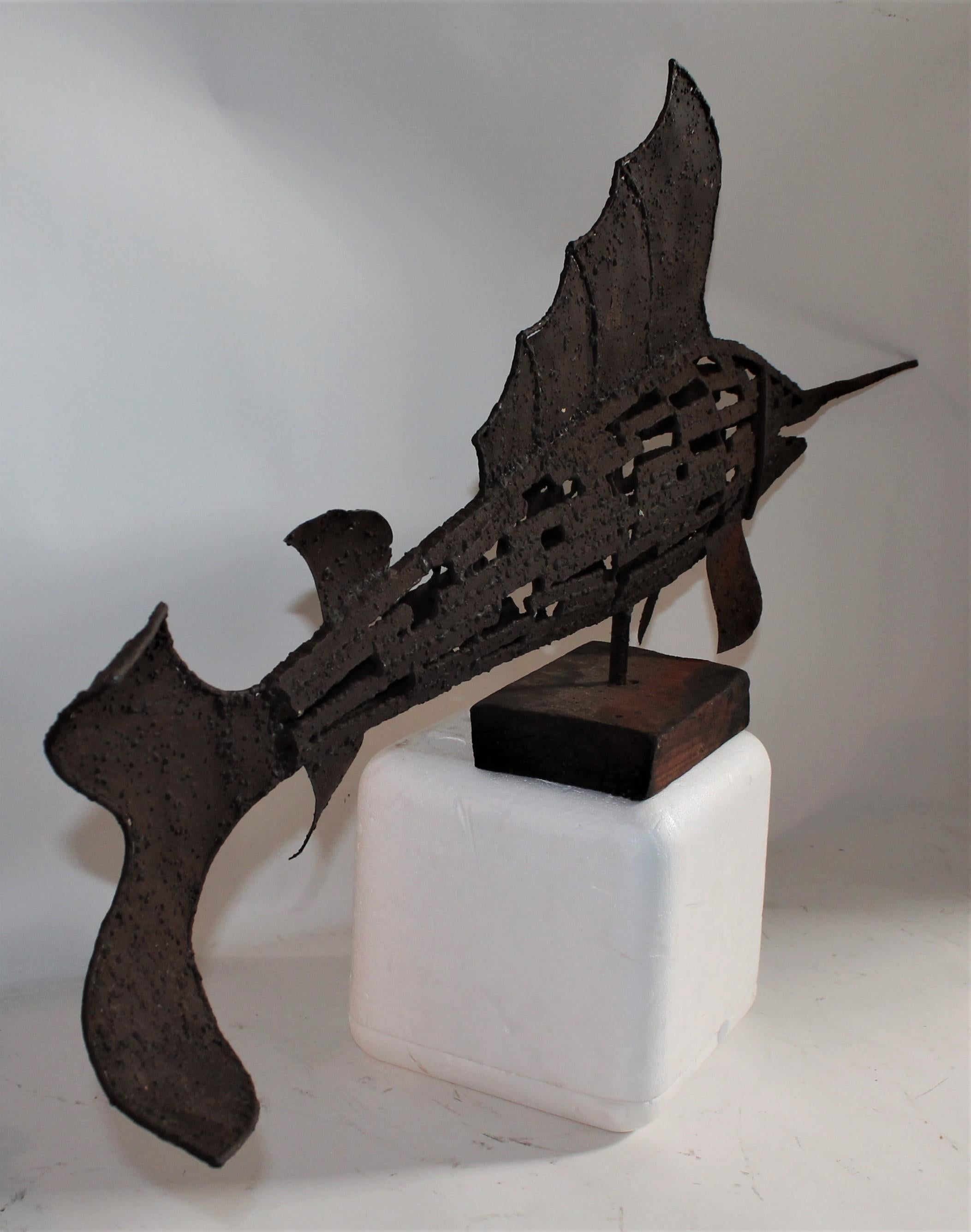 Early 20th century swordfish folk sculpture in good condition on original wood block base. This cast iron handmade sculpture is in great condition and very heavy. Resembles a large handmade weather vane. Great form!