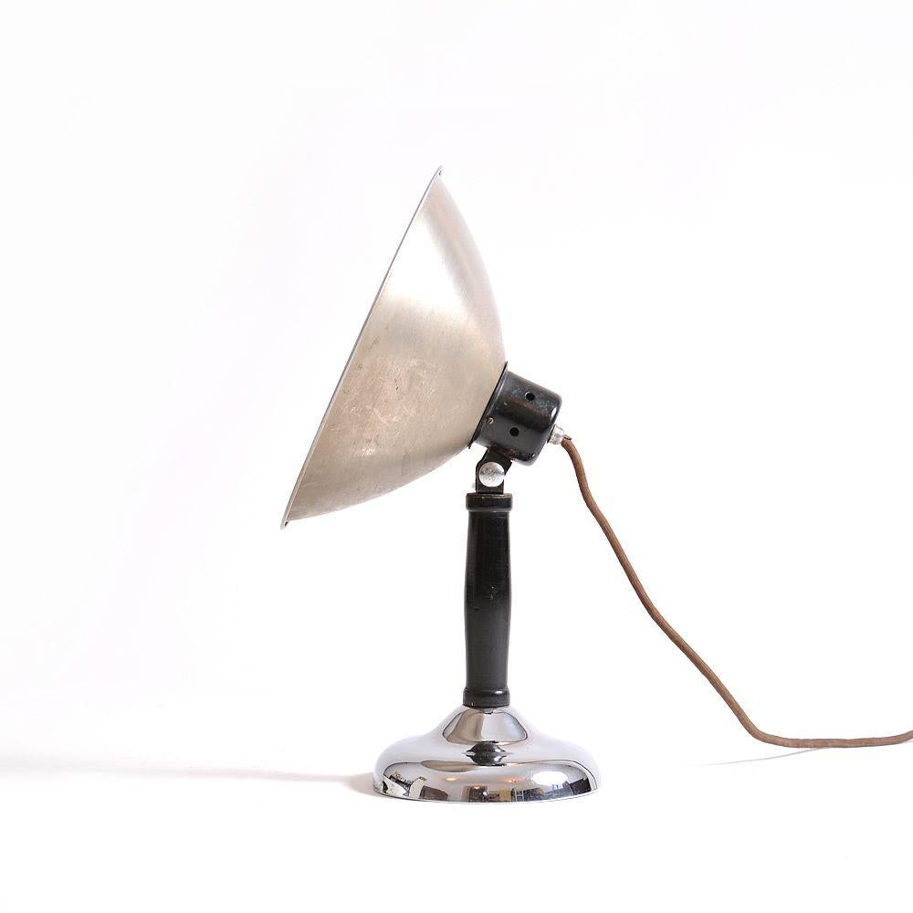 Industrial table lamp, originally used as a photo lamp for photoshoots. Made of metal construction and chrome shield and base. Very good condition with only minor wear. Fully functional, new wiring, European plug.