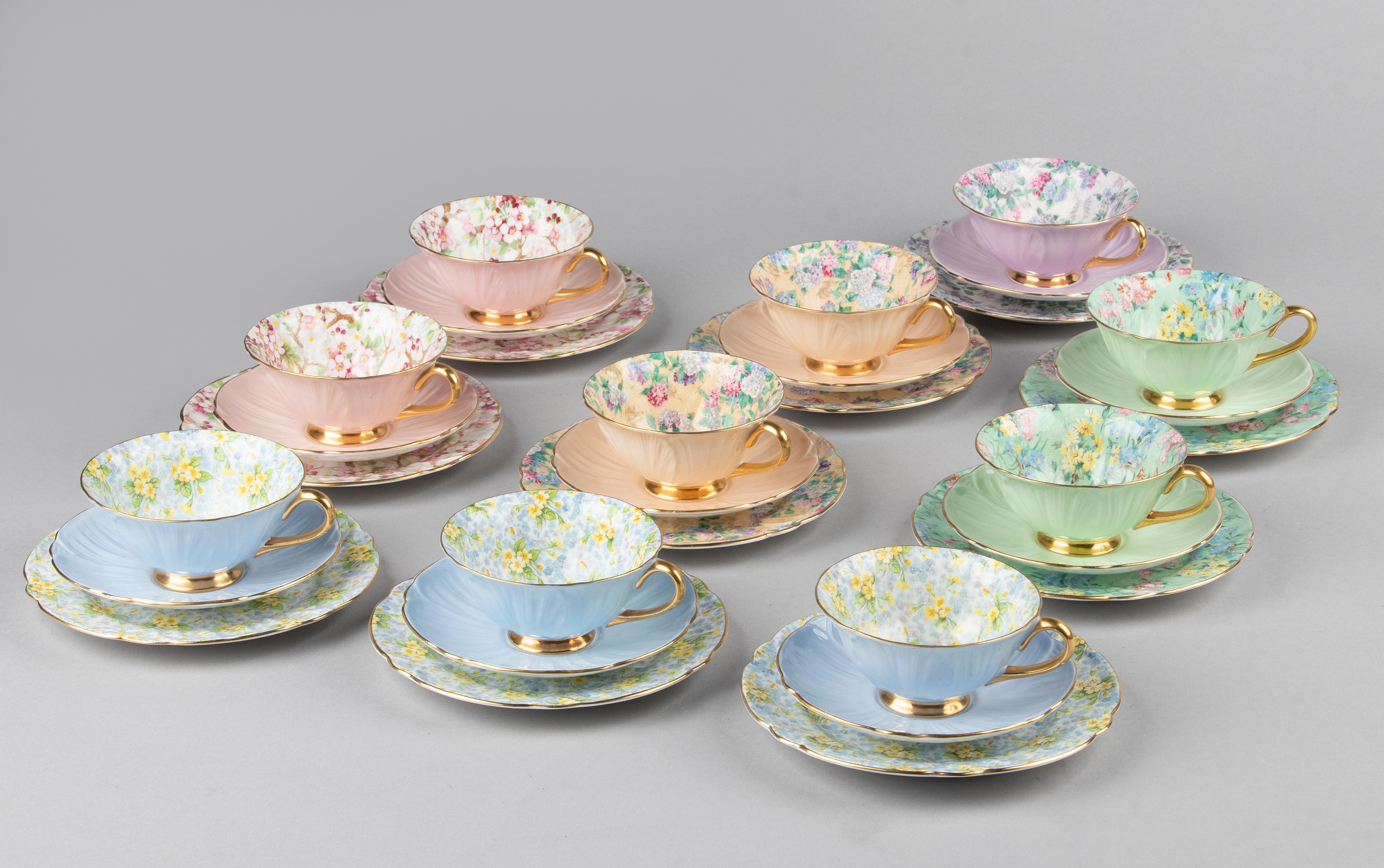 Beautiful set of 10 porcelain tea trios from the English brand Shelley. The cups and saucers are decorated with different chintz patterns on the inside, and leaf-shaped bottom. The cake plates and the cups and saucers match each other. Rare set.