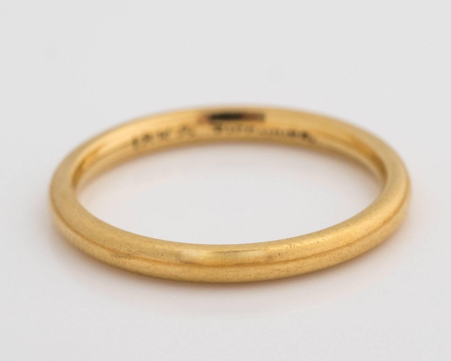 1930s Art Deco Tiffany and Co. Wedding Band Ring - 18 Karat Yellow Gold Band
Features a smooth, rounded 18 Karat Yellow Gold band. The band may be engraved if you like. This Art Deco era ring hails from the 1930s and is ready to write another