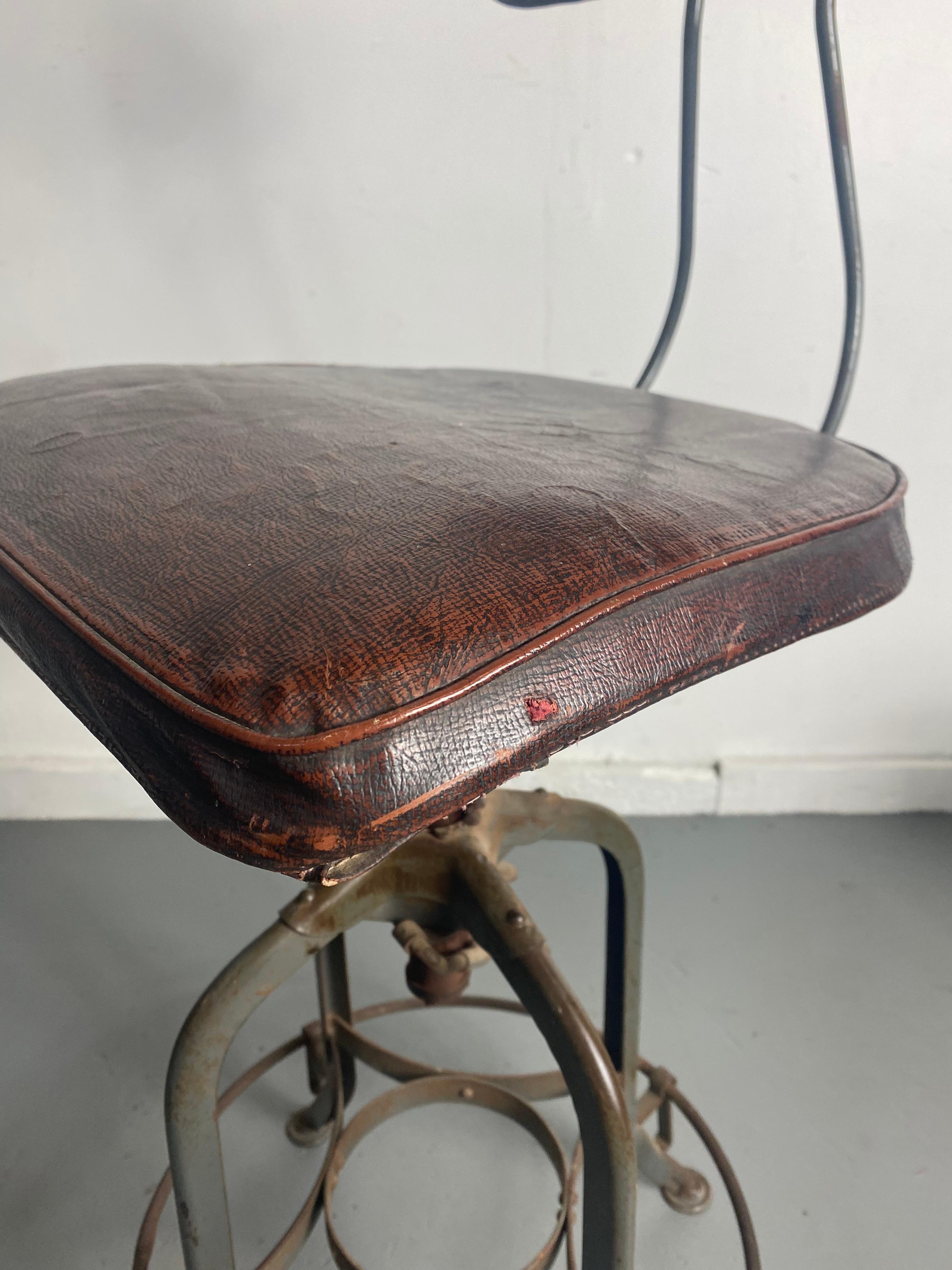 1930s Toledo Industrial Adjustable Height Swivel Stool .Orig Oil Cloth Covers In Distressed Condition In Buffalo, NY