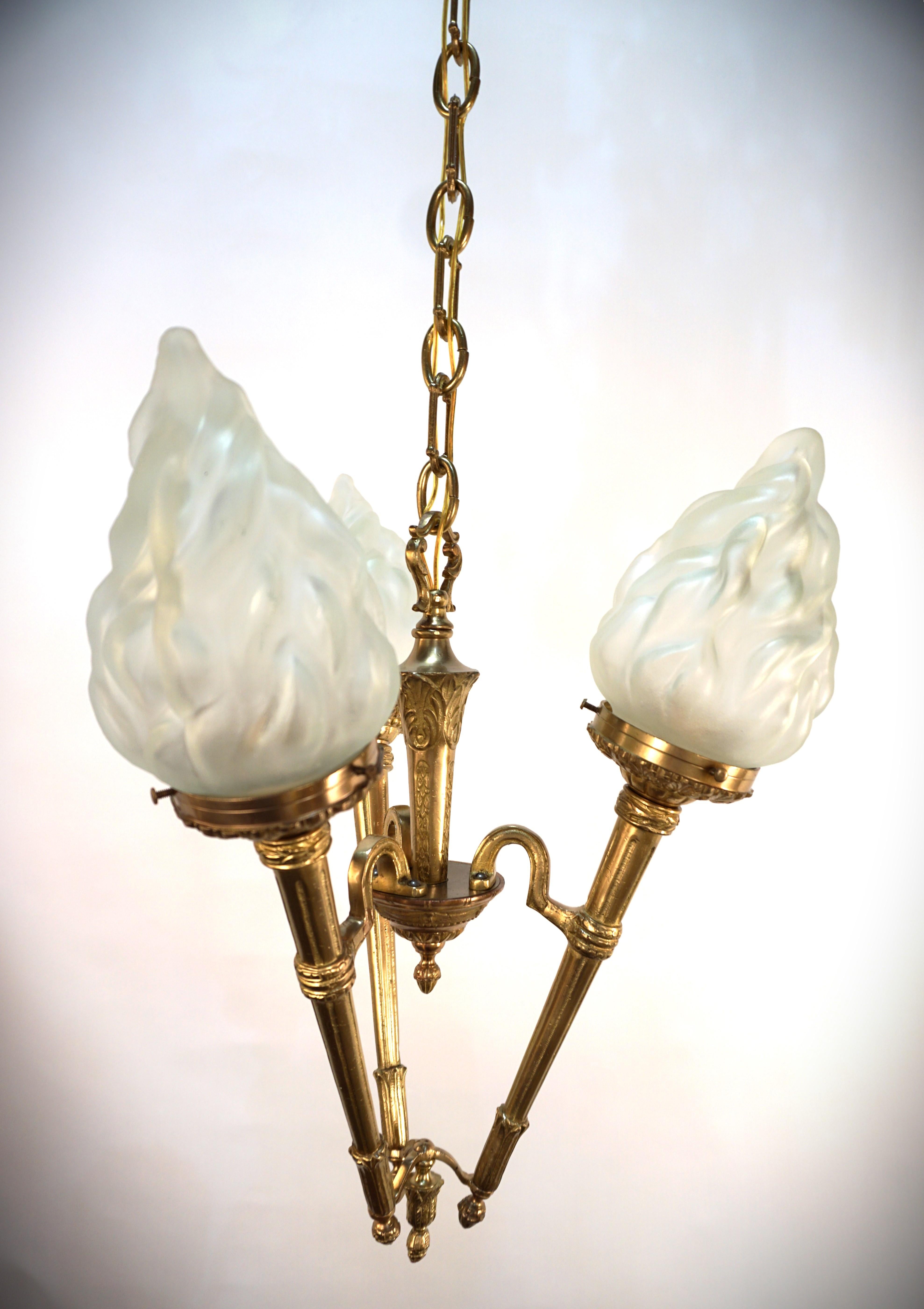 Clear frost torch flame glass shade and bronze 1930 chandelier.
Professionally rewired and ready for installation.
Three lights, 100 max each. 
Measurment: width 15