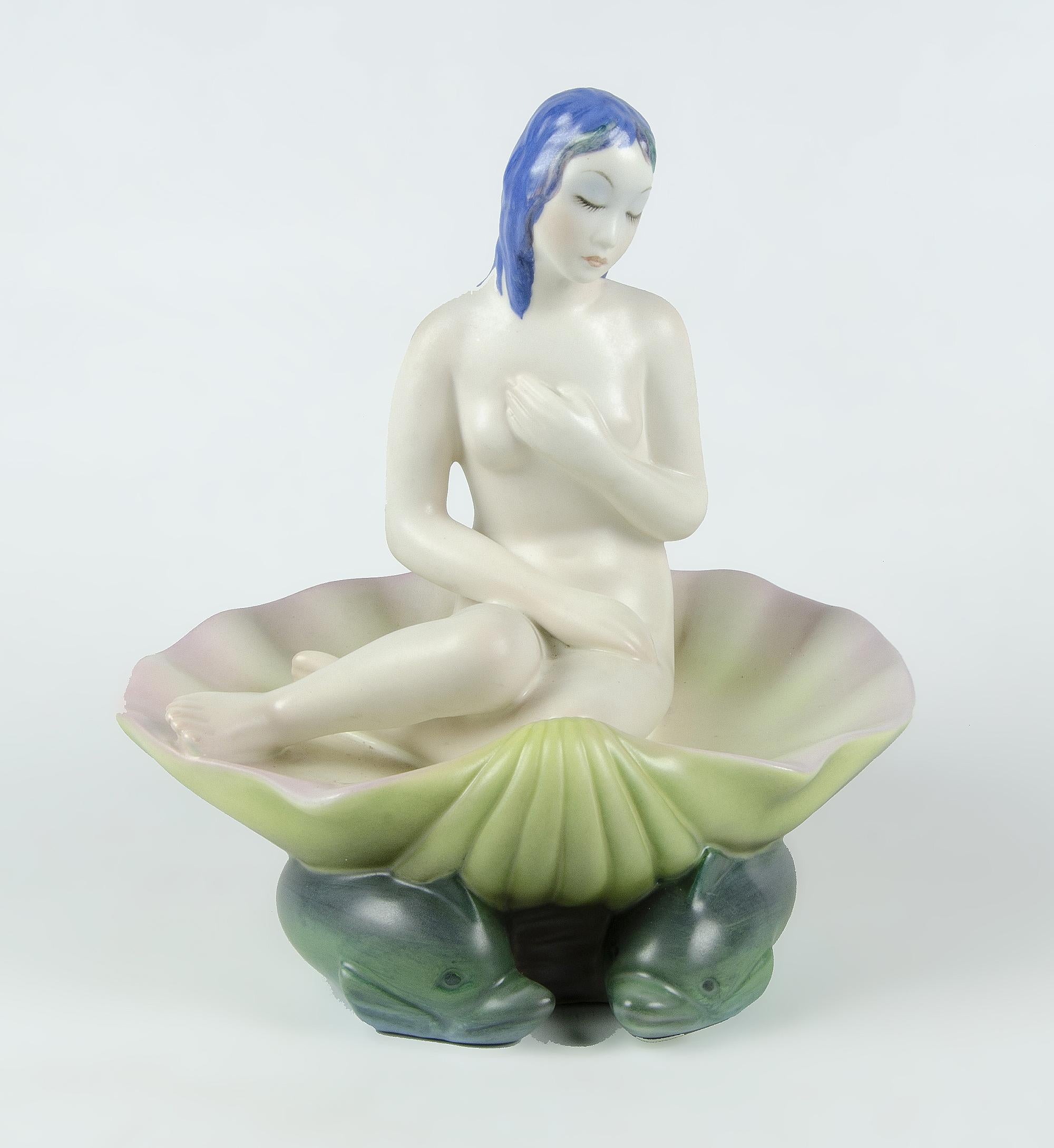 1930s Torino glazed porcelain sculpture of seated Venus on shell over dolphins, manufactured by Lenci, Italy

By: Lenci
Material: ceramic, porcelain, enamel, paint, clay
Technique: cast, pressed, glazed, enameled, painted, hand-painted,