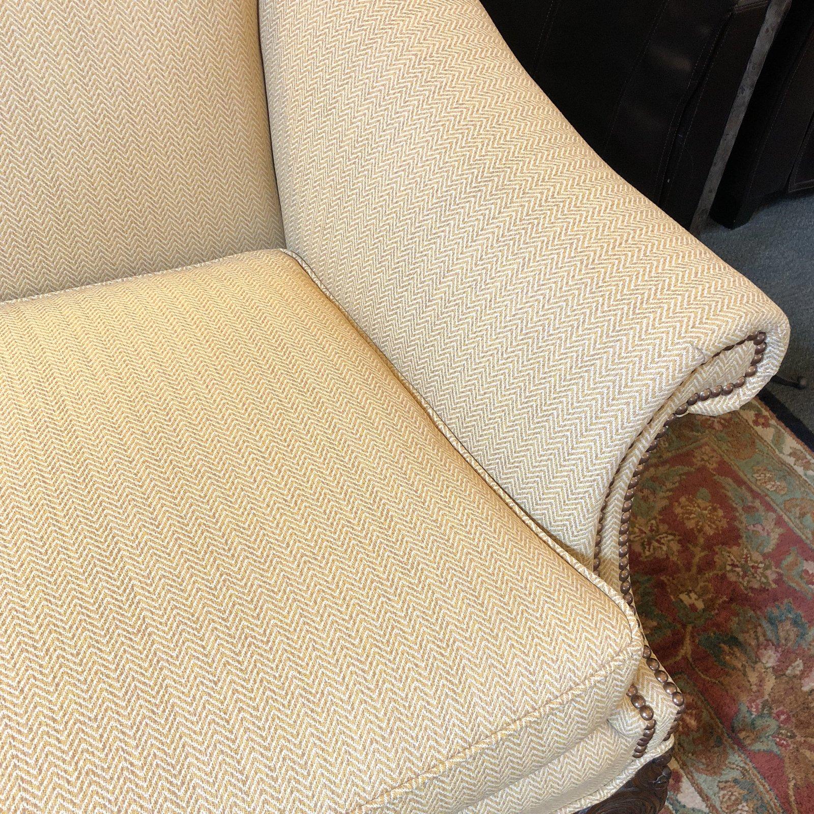 A Classic camelback sofa. Custom upholstered in a muted chevron pattern, the fine curves are highlighted with antiqued brass nailhead.

 