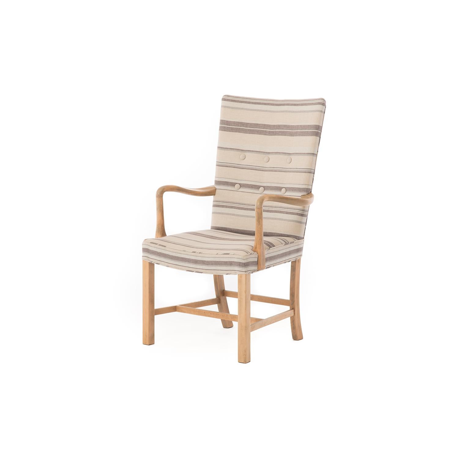 This 1930s high backed lounge chair by Fritz Hansen has been restored in a cooling striped Rivera linen by Raoul textiles. The frame has been fully restored for structure. The frame finish has been updated but the lovely patina this piece has