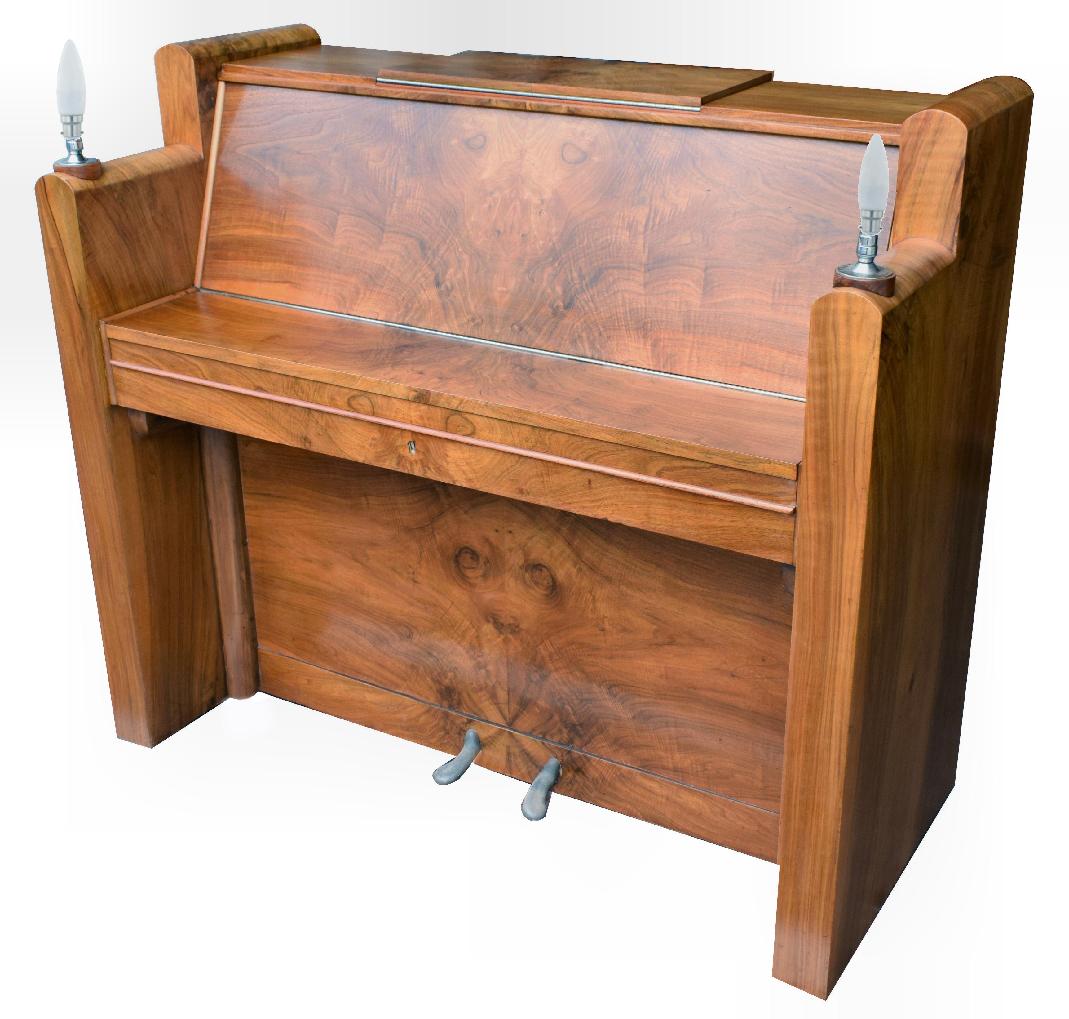Stunning 1930s Iron framed Art Deco piano by Berry of London, England. This fabulous looking piano has been veneered in a heavily figured walnut. The whole piano, as you can see, has a brilliant, desirable Art Deco shape. All the keys are in good