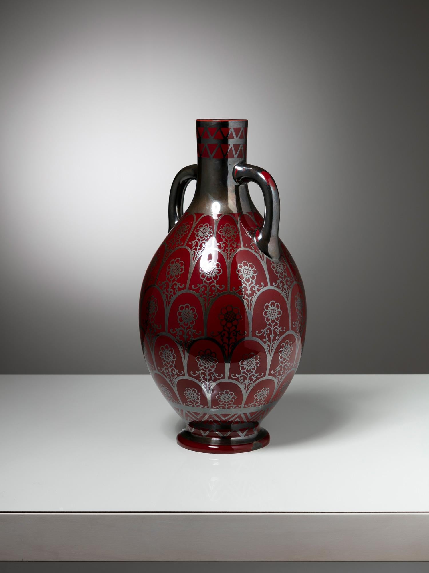 Large ceramic vase by Righard Ginori.
Dark red background with silver decoration.
