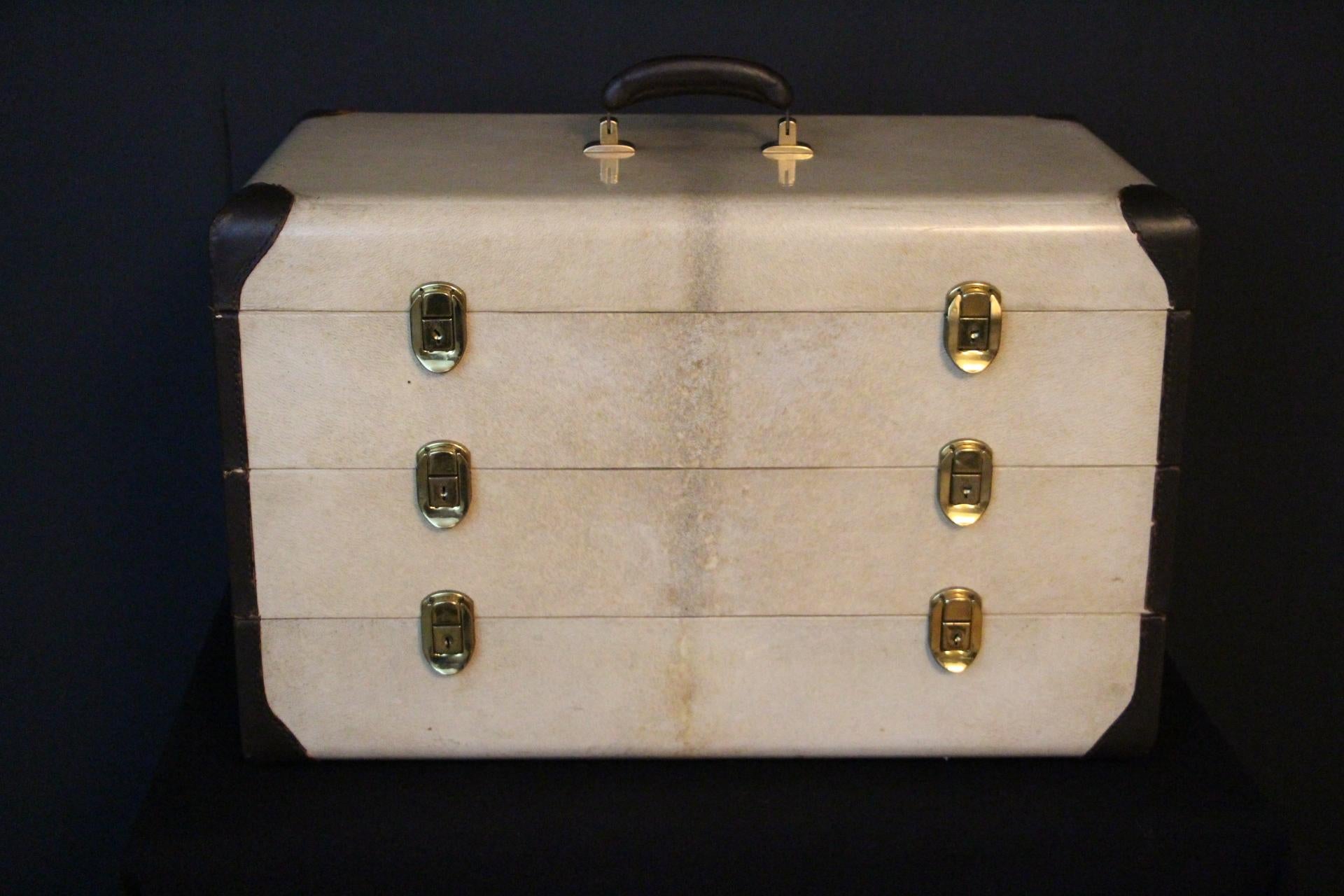 This little steamer trunk is so extraordinary...All made in soft ivory color vellum leather with chocolate color leather trim and matching sturdy top handle, it splits into 3 removable sections. Its back is perfectly identical to its front. Indeed,
