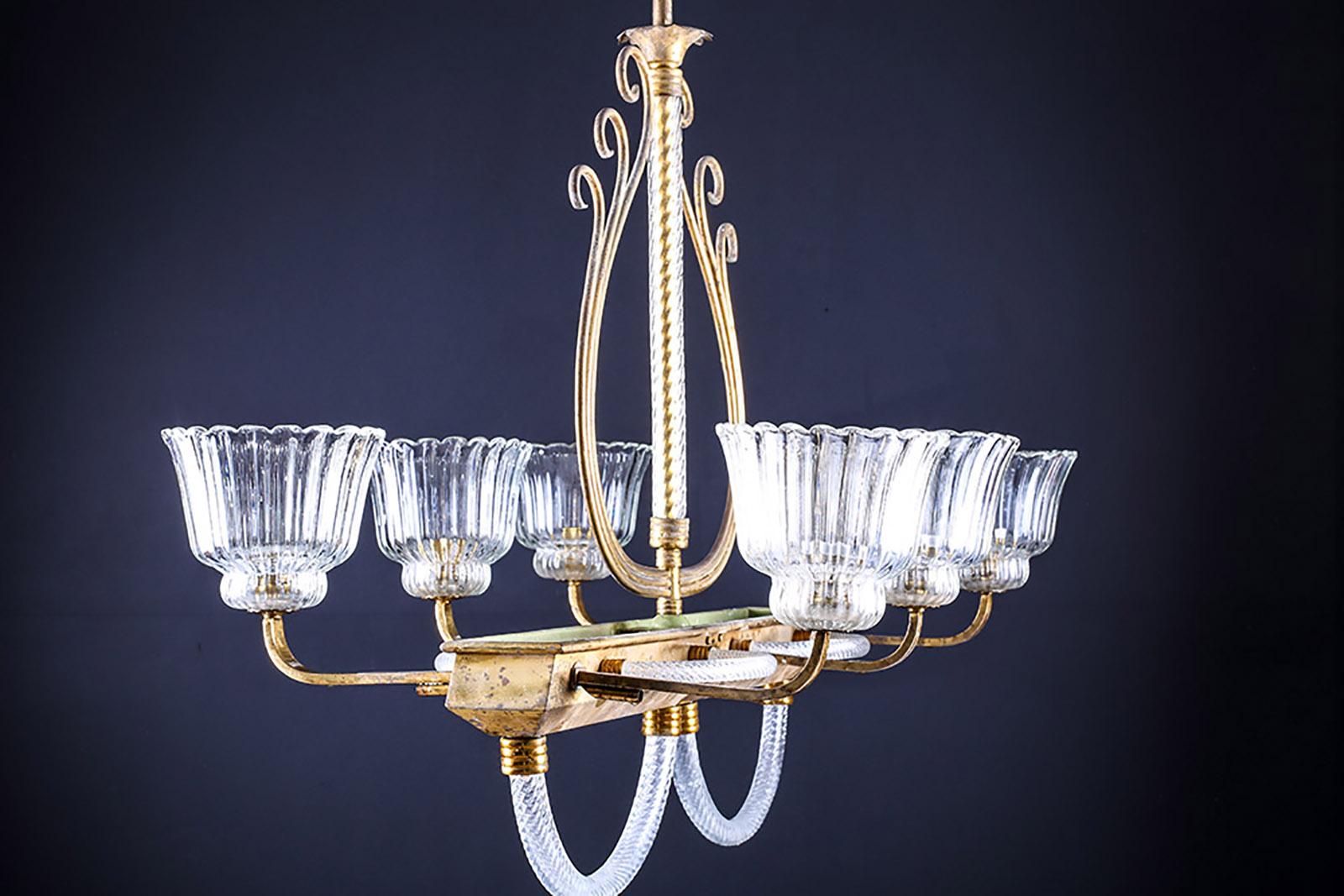 1930'S Venetian brass & clear murano glass chandelier By Barovier & Toso.

Option: height can be shortened if necessary.
Total depth: 23? – 58.4 cm
Total height: 52” – 132 cm
Total width: 27? – 68.5 cm