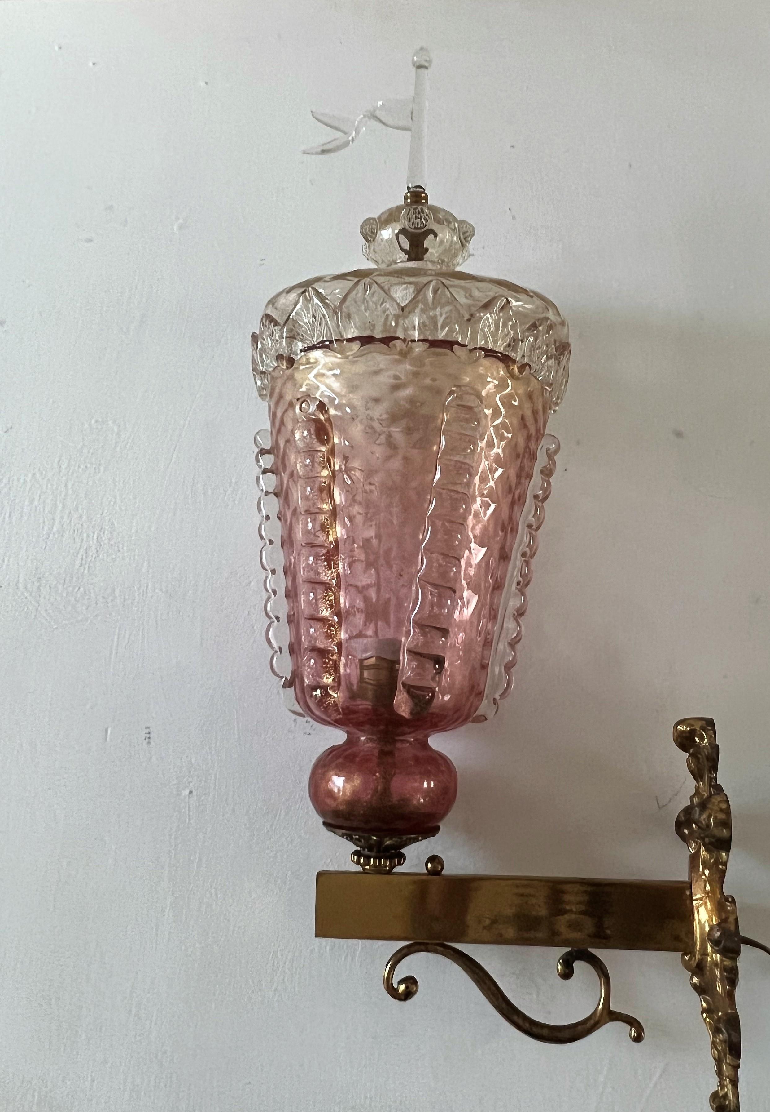 Large sconce manufactured in Murano glass in the shape of a Venetian Medieval Lantern. 
Attributed to the Barovier & Toso factory and most likely manufactured between 1920-1940.
The glass has pink and clear tones as well as gold flecks throughout.