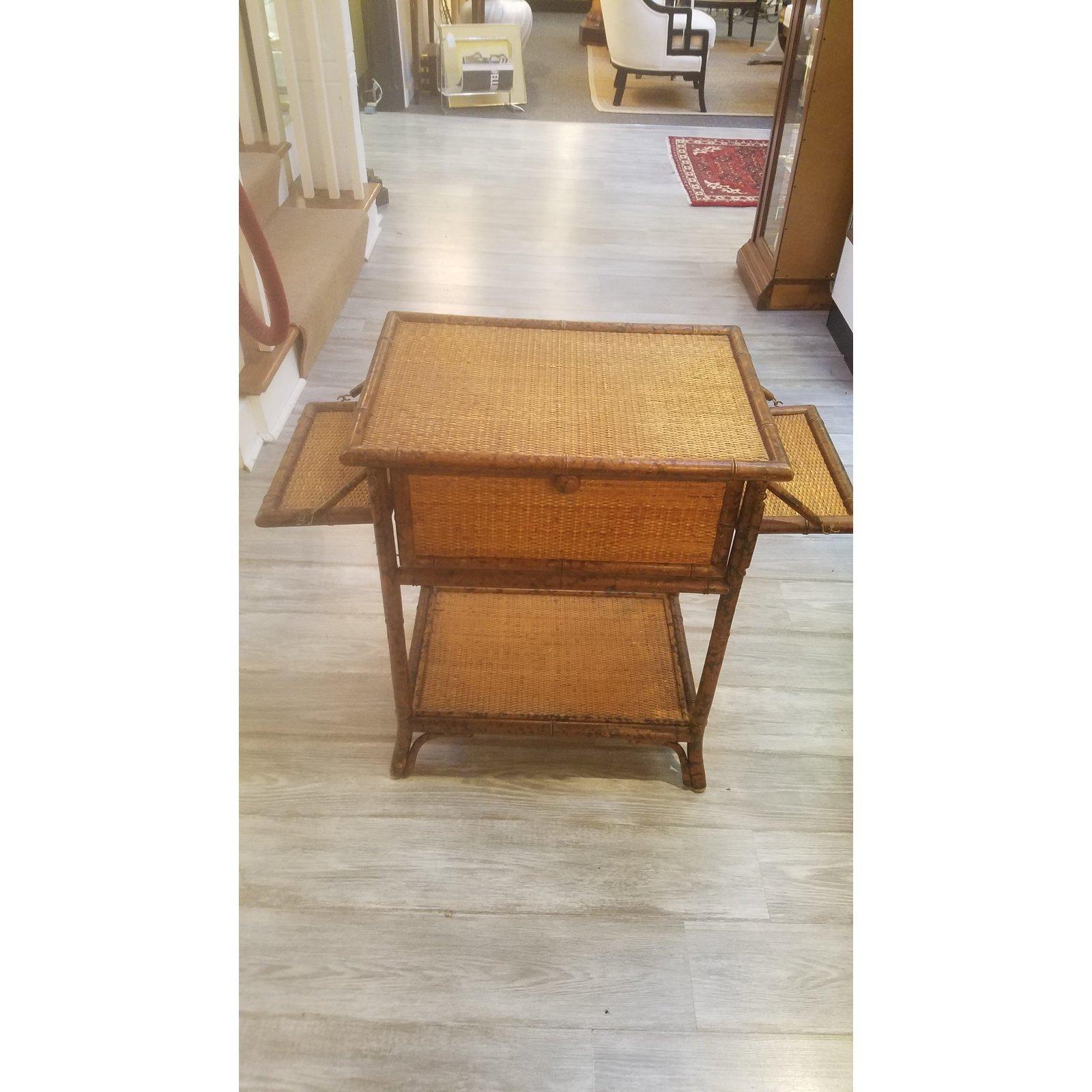 Charming Victorian style table with three shelves that can be left opened revealing a shelved storage area or closed there is also a second lower shelf. The shelves are on the front and both sides. The bamboo frame with a tortoise pattern finish.