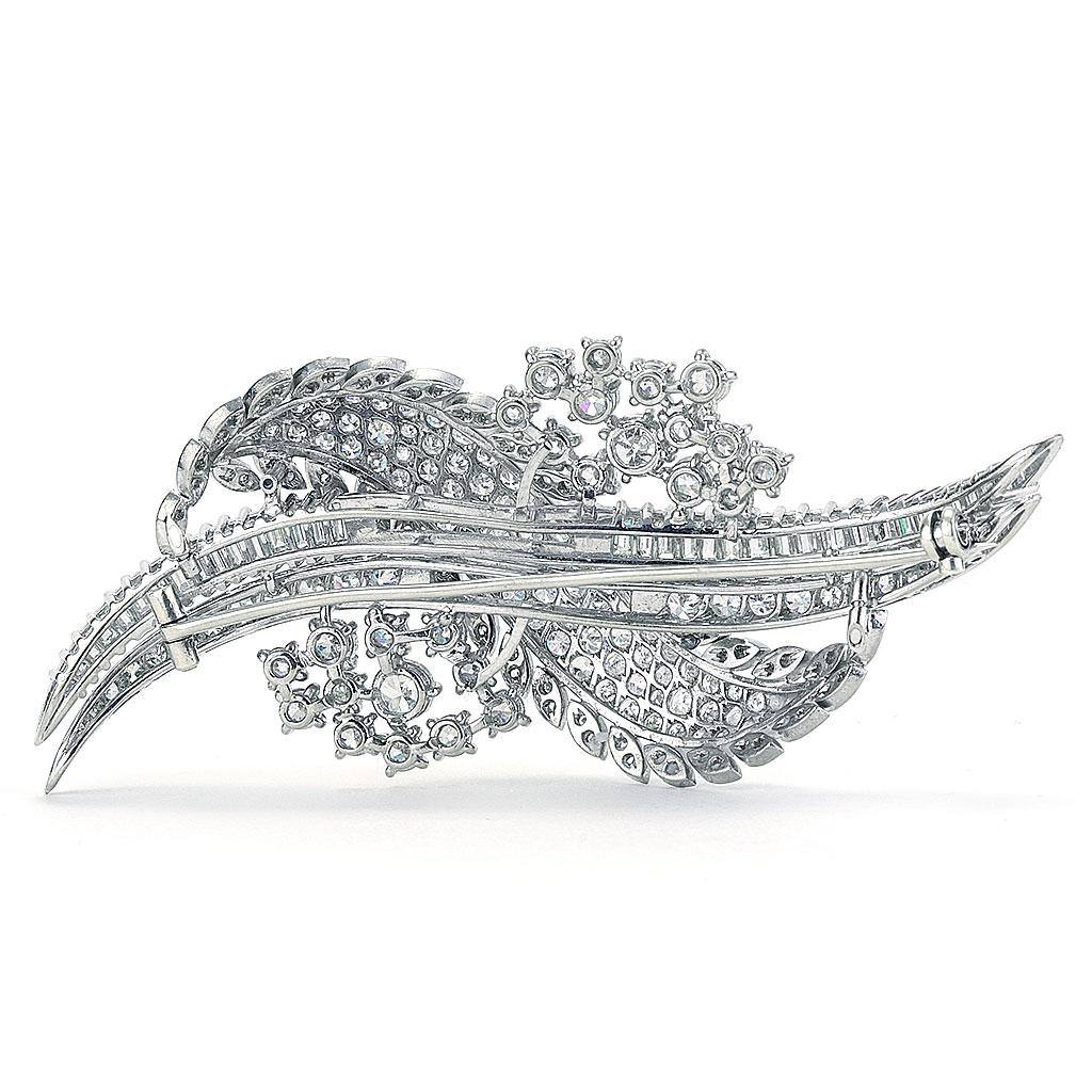 This pin is made of a combination of 18k and 14k white gold. It weighs 21.30 DWT (approx. 33.13 grams). It contains 36 G color diamonds, weighing 3.00 CTTW. 68 single cut G color diamonds weighing 1.00 CTTW, 102 European cut G color, and diamonds