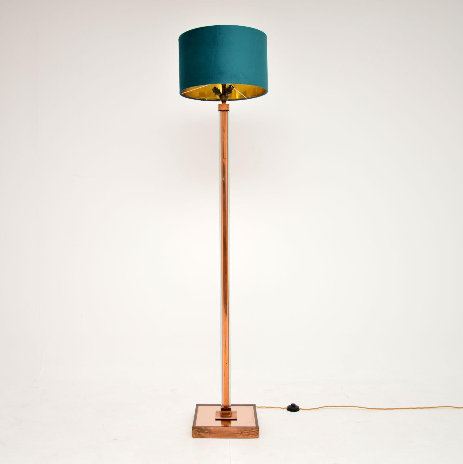 A beautiful original Art Deco floor lamp in copper, peach glass and acrylic. This was made in England, it dates from the 1930’s.

It has a stunning design and is of superb quality. The main copper frame is flanked by clear acrylic sheets, this sits